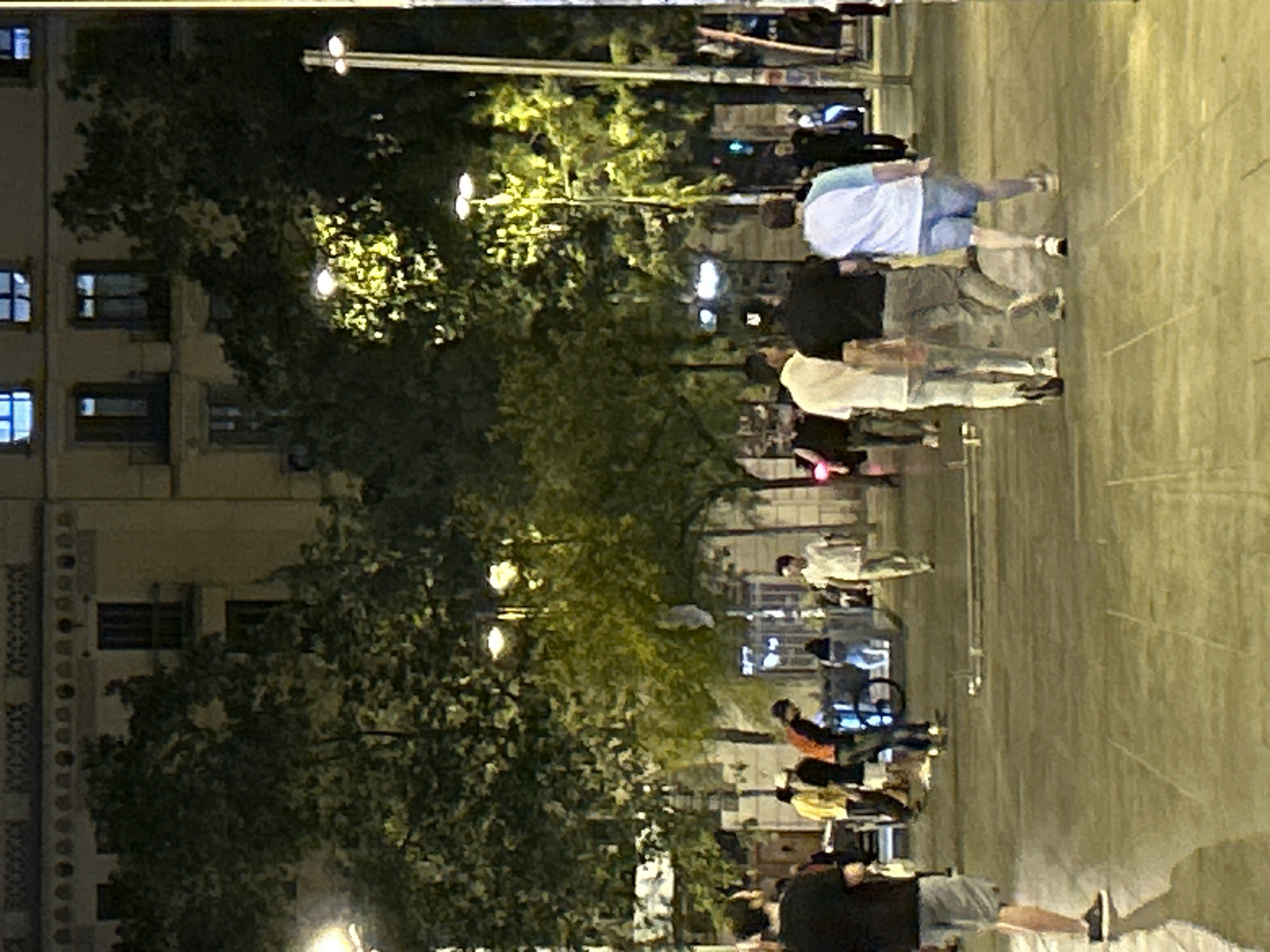 Friday night street hang near a Barcelona transit plaza