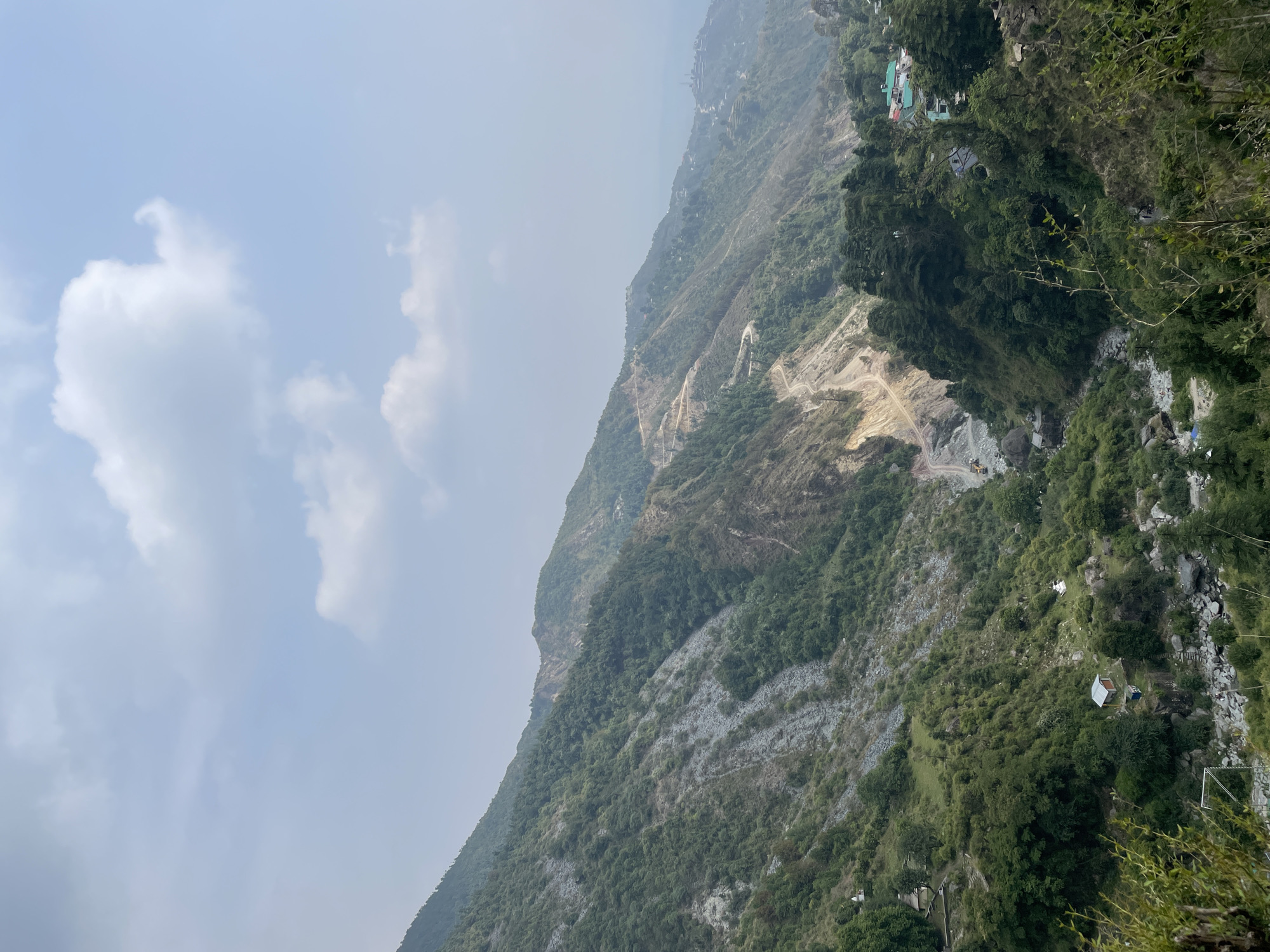 Lone hiker walks mountain paths in Bhagsu, India