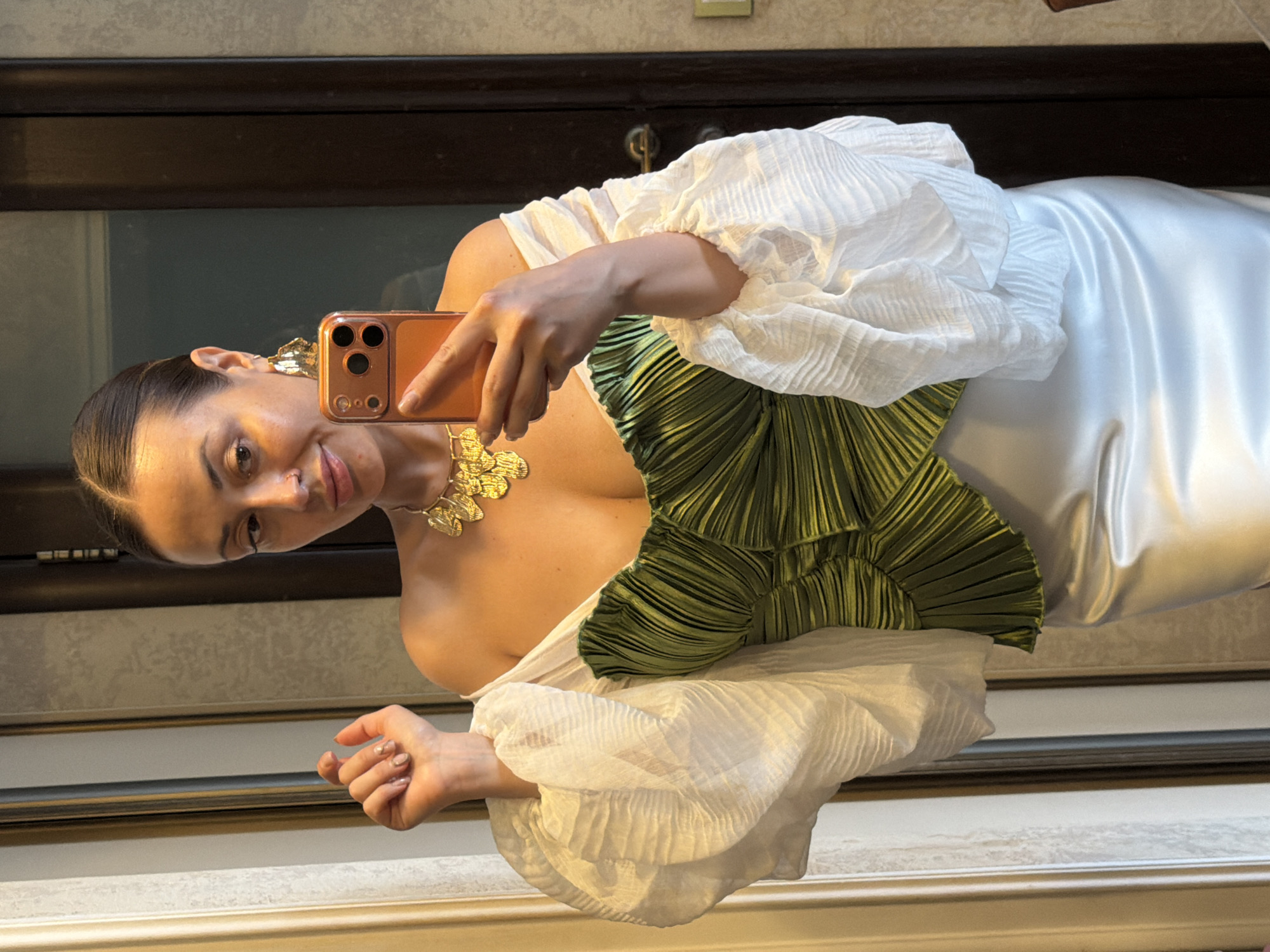 Woman takes mirror selfies in green outfit, Krasnoyarsk