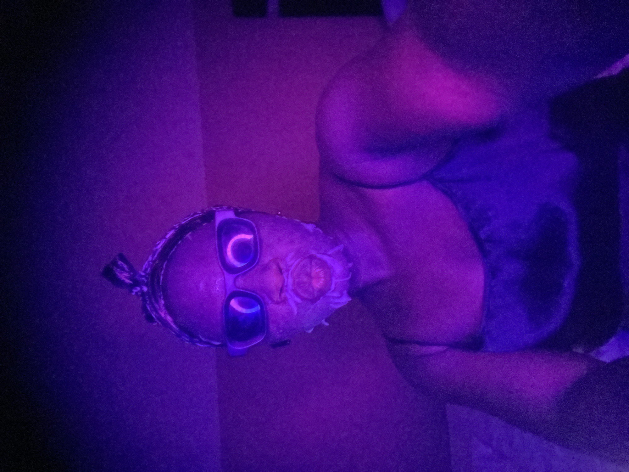 Person spotted in colorful lighting wearing mask, sunglasses in Nigeria