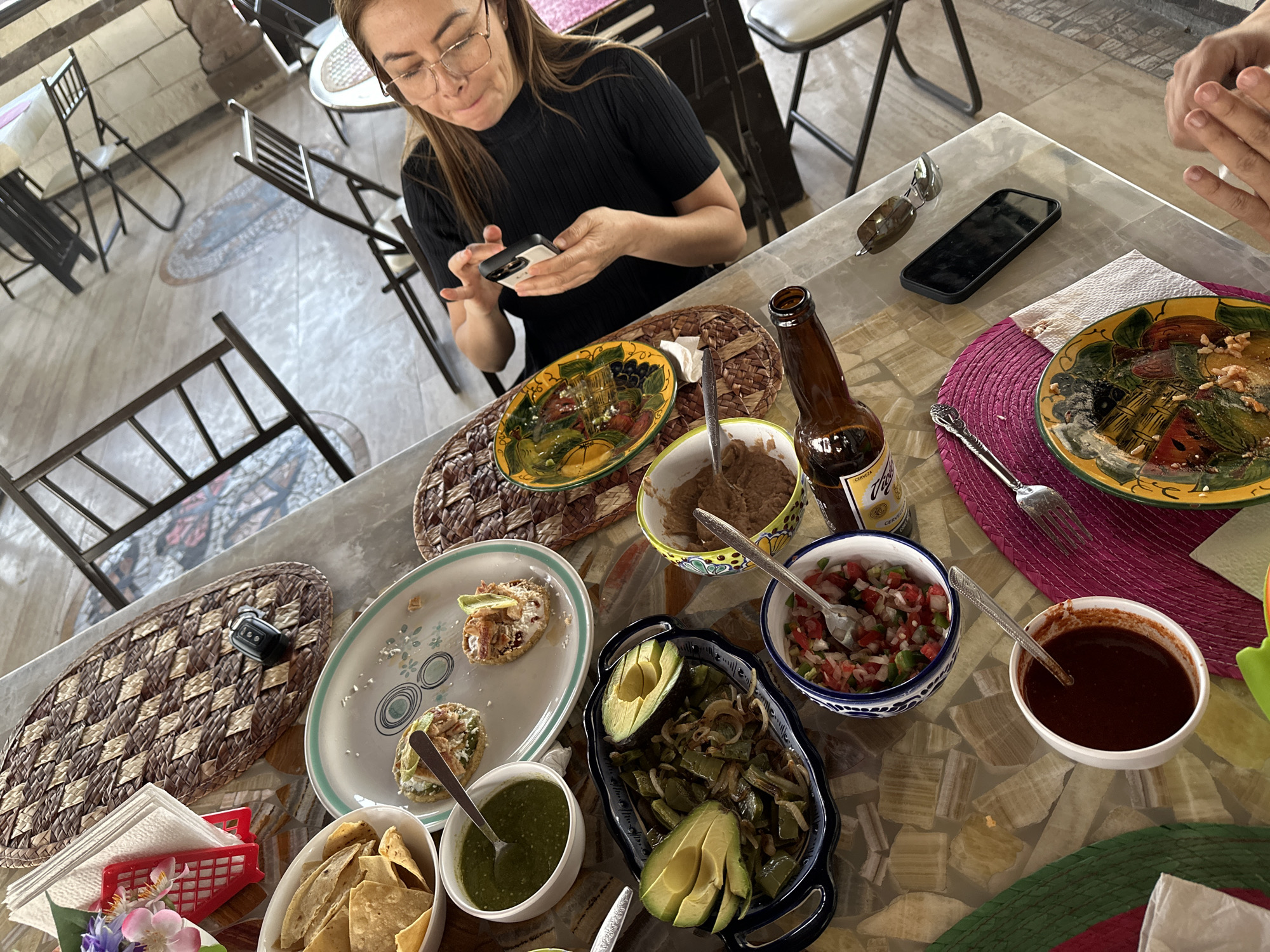 Woman dines while using phone in Mexican town