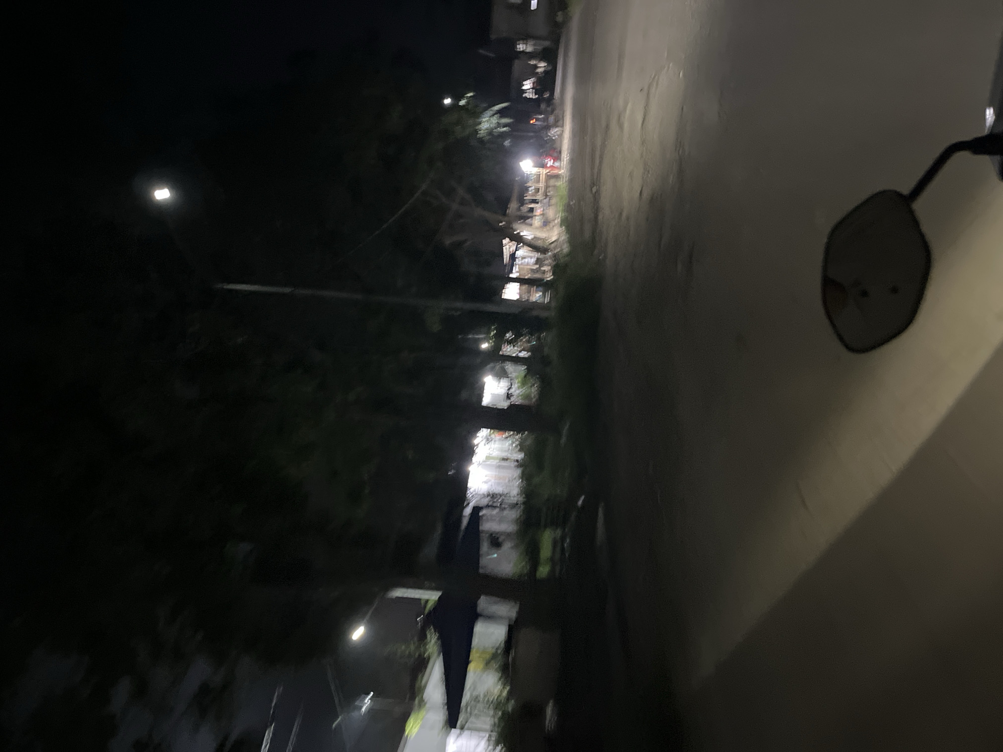 Late-night motorcycle ride through rural Indonesian streets and construction zones