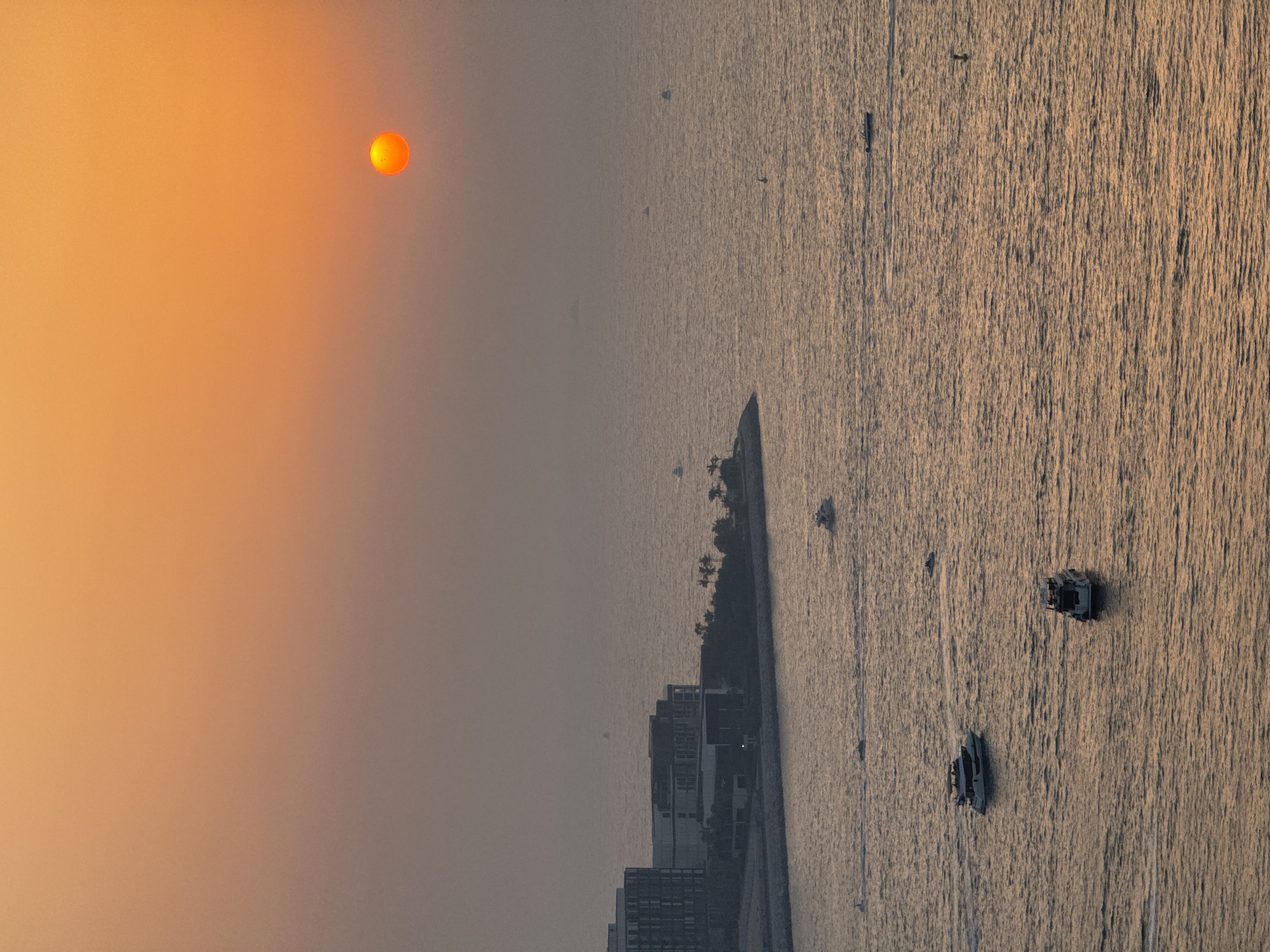 Sunset over Dubai's coast, quiet afternoon indoors