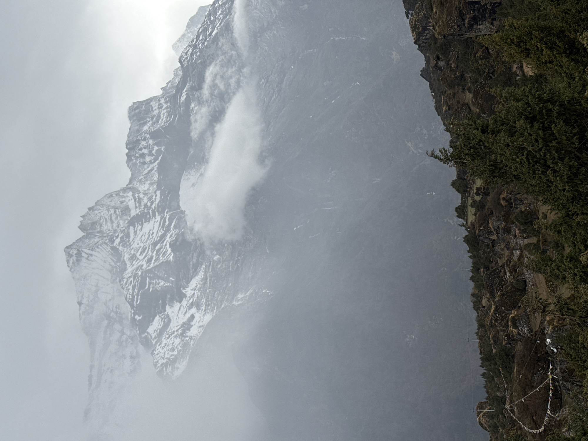 Heavy fog shrouds snow-capped mountains in Namche, Nepal