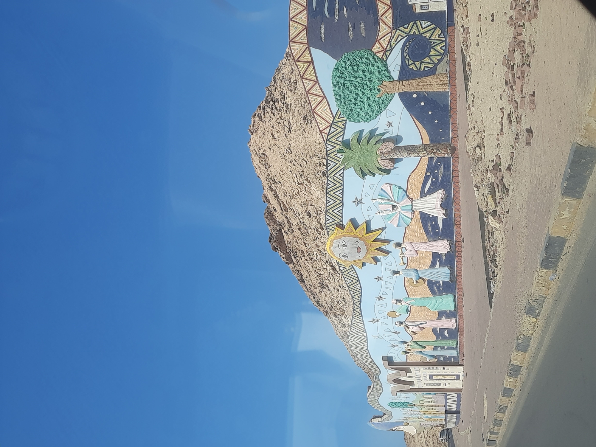 Colorful mural spotted on rocky outcrop in Al Hadaba