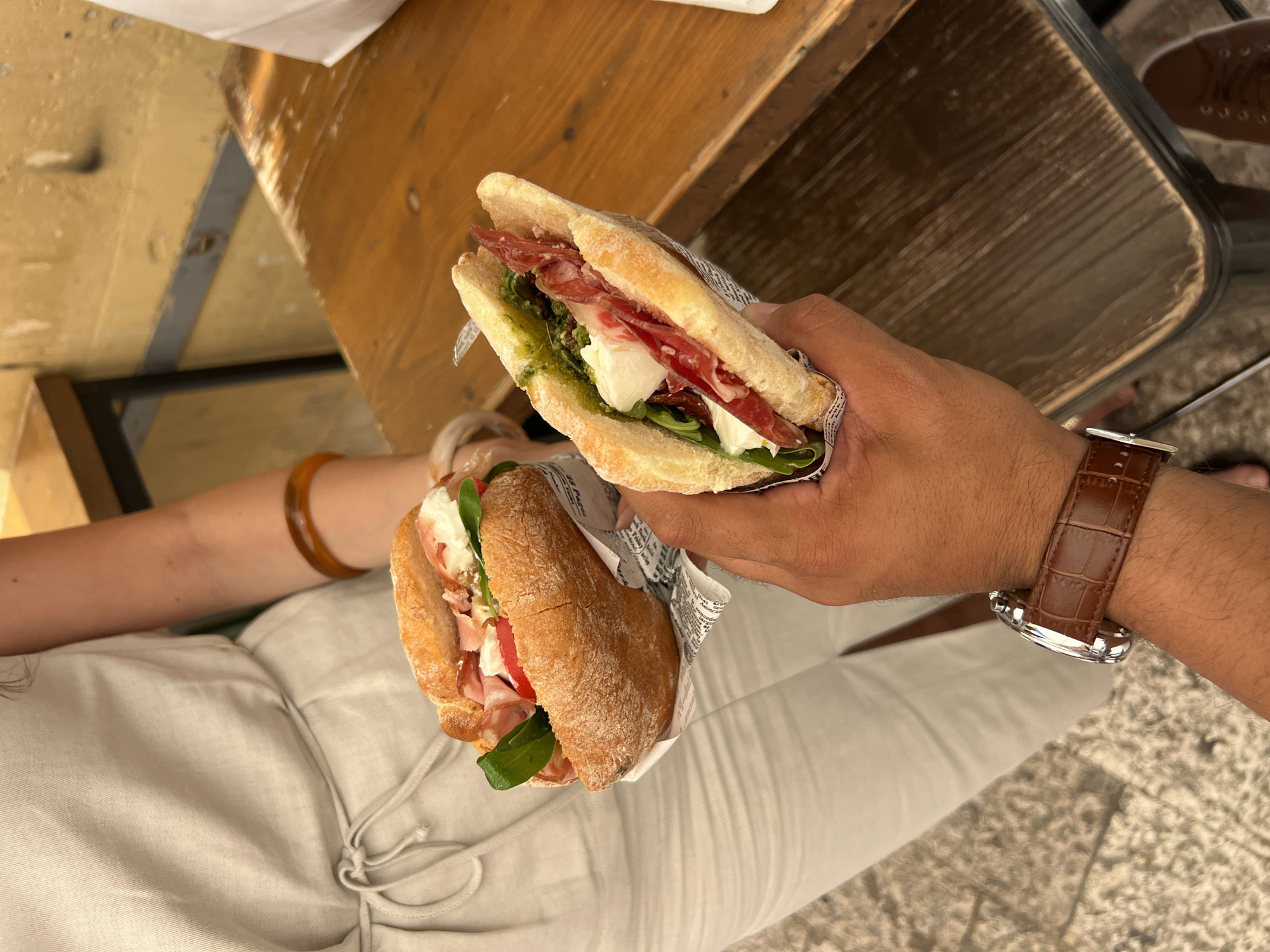 Two diners share prosciutto panini in Matera, Italy
