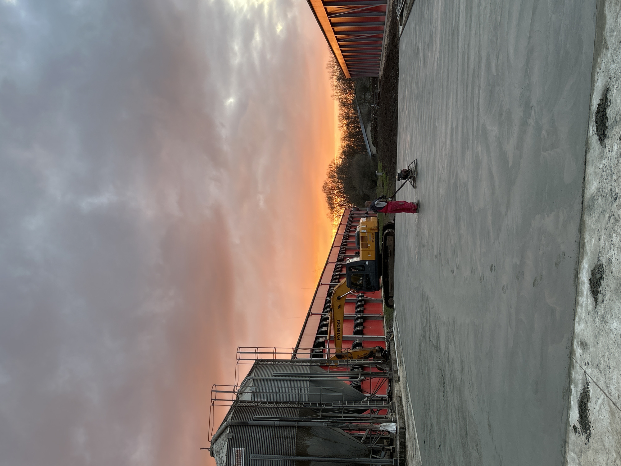 Construction worker finishes concrete at sunset in Donchevo Bulgaria