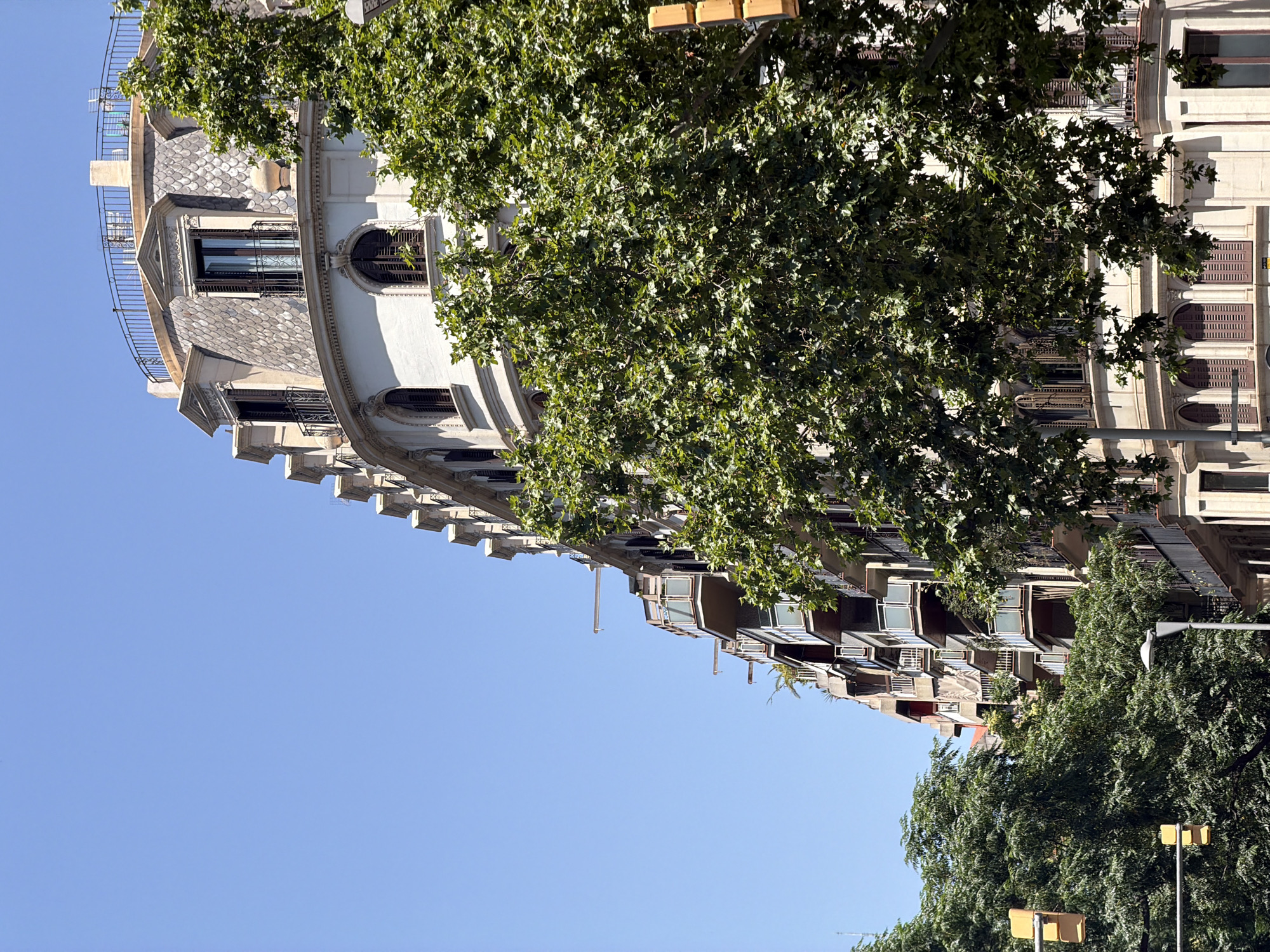Barcelona street walk mixing historic facades, modern architecture, and luxury retail