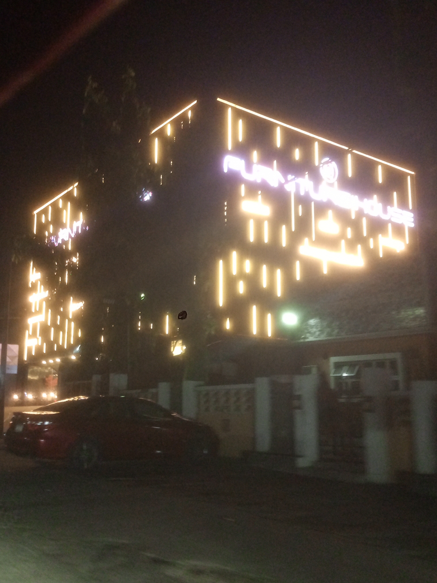 LED-lit warehouse building spotted with red sports car in Gwarinpa