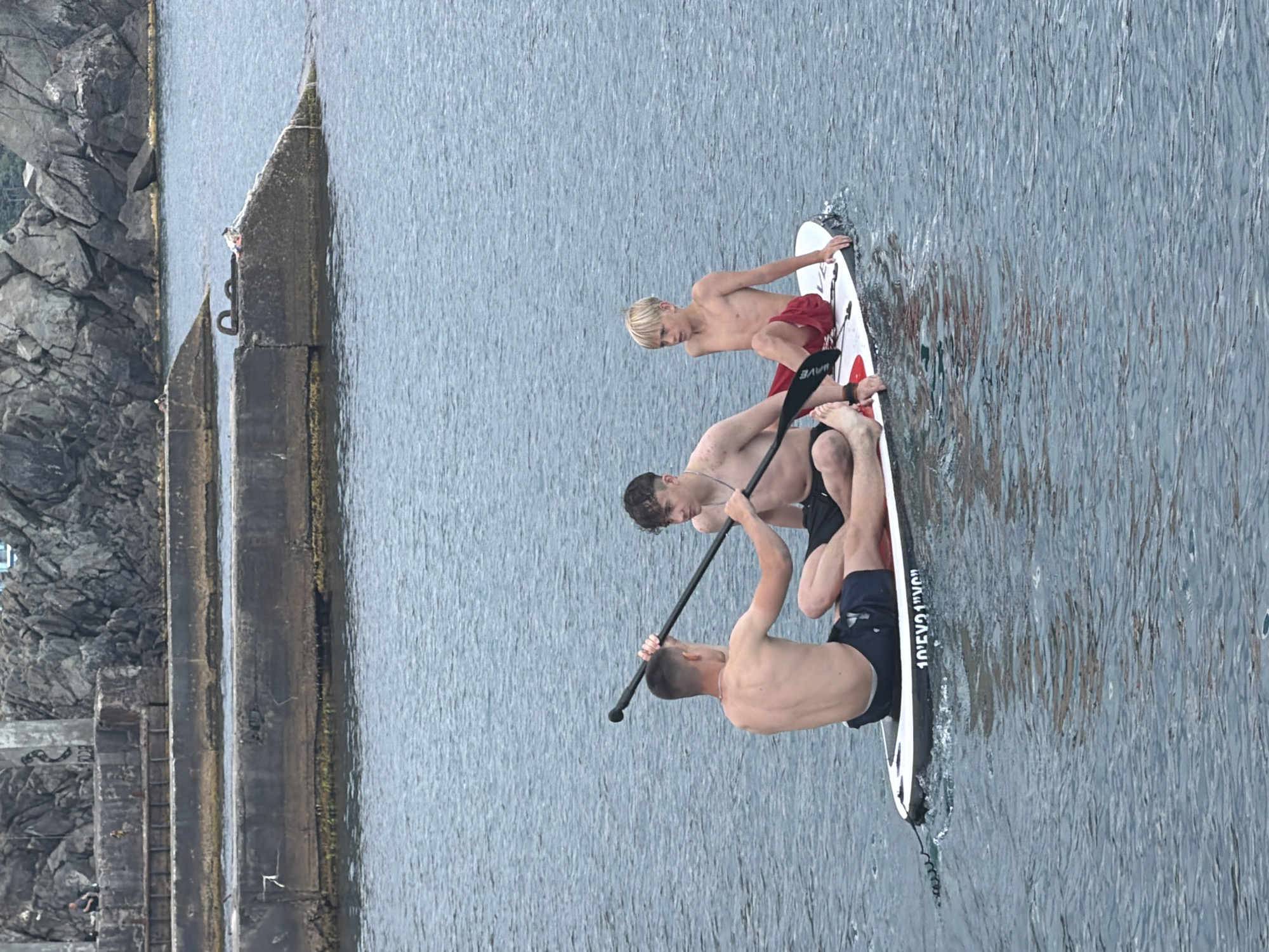 Summer day at Partenit's pebble beach, paddleboards and all