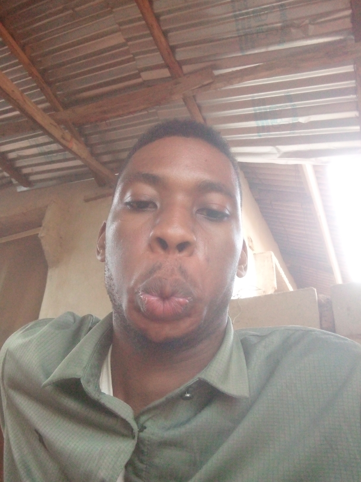 Man documents casual moments under metal roof shelter