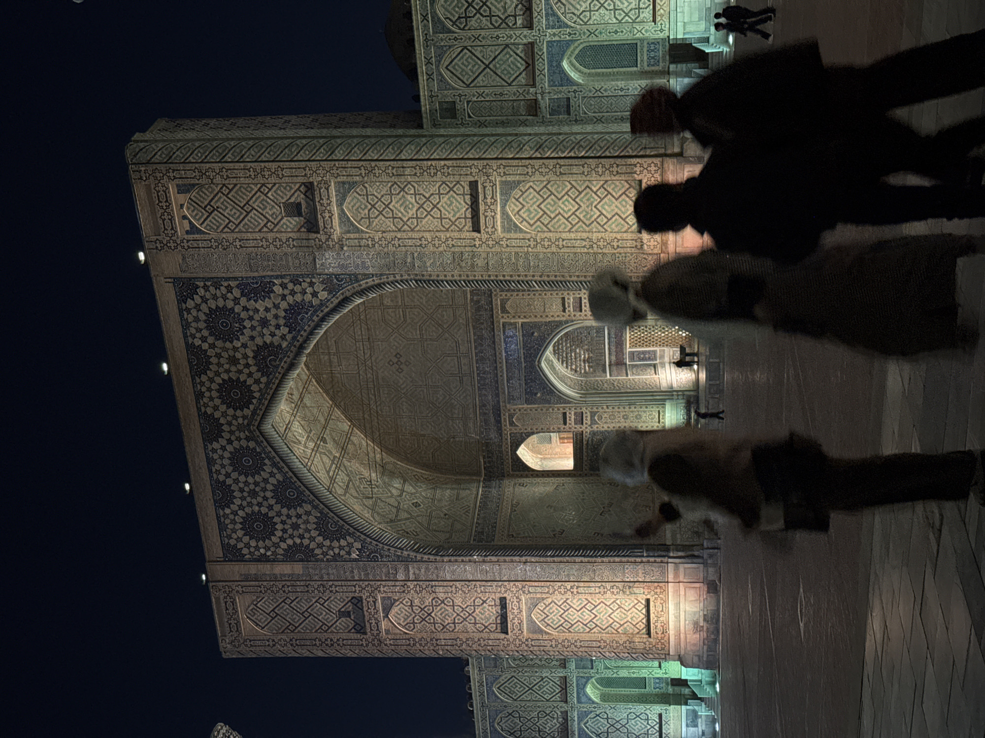Historic Samarkand landmarks illuminated during evening tourist activity