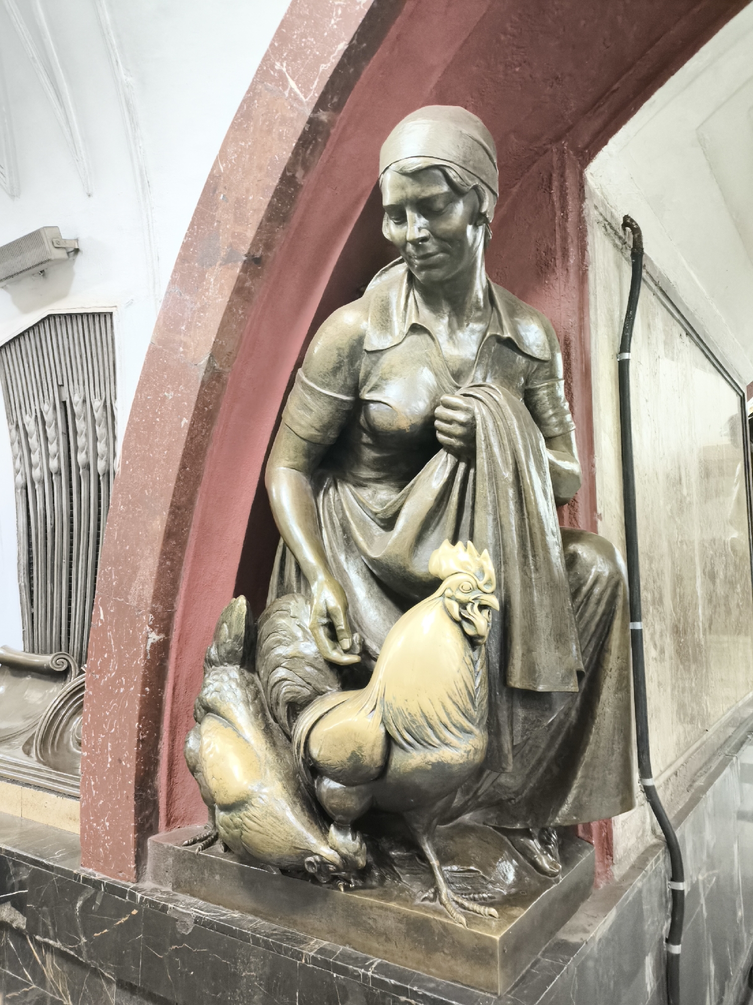 Bronze sculptures and a glass-roofed arcade in a themed shopping district
