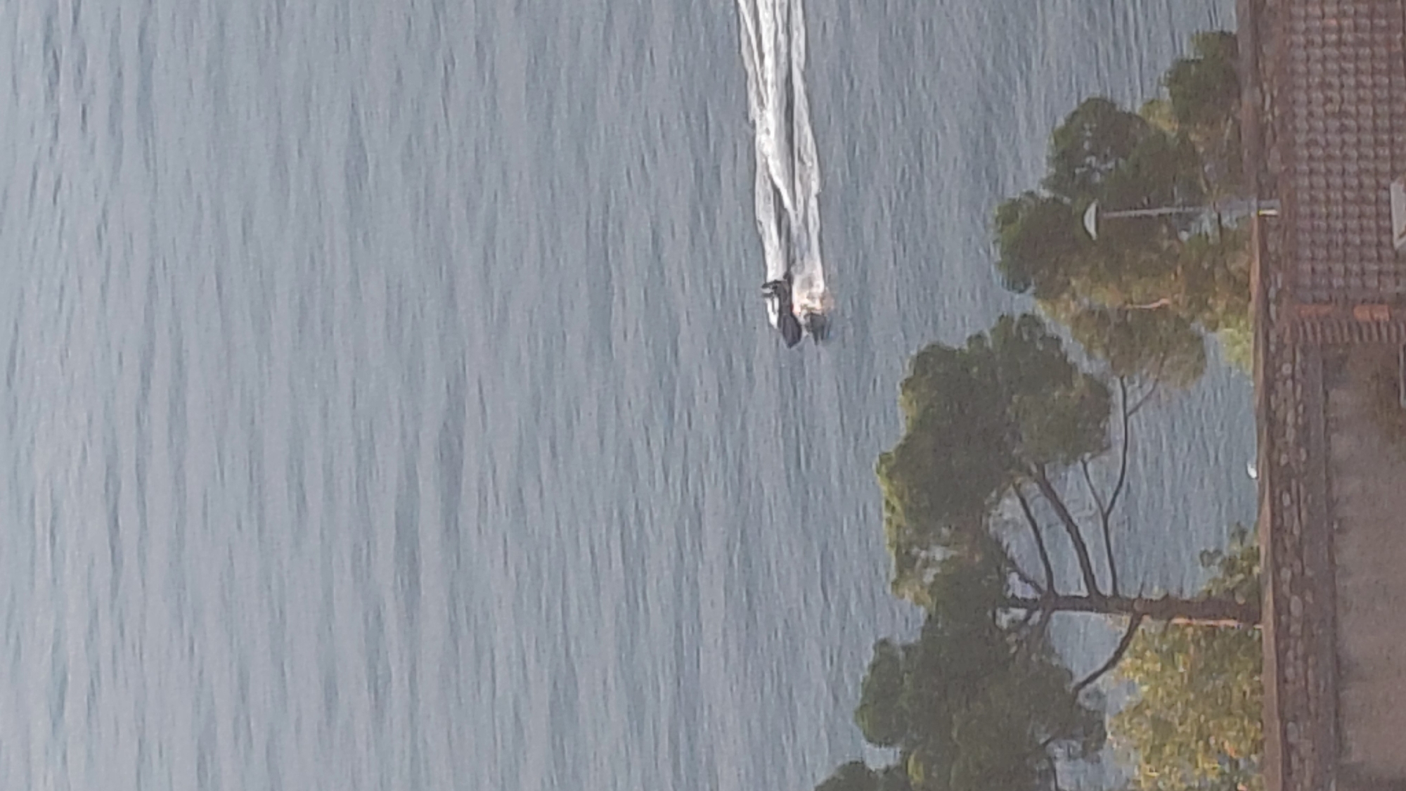 Jet ski on calm water, cat candles melting nearby in Aegio