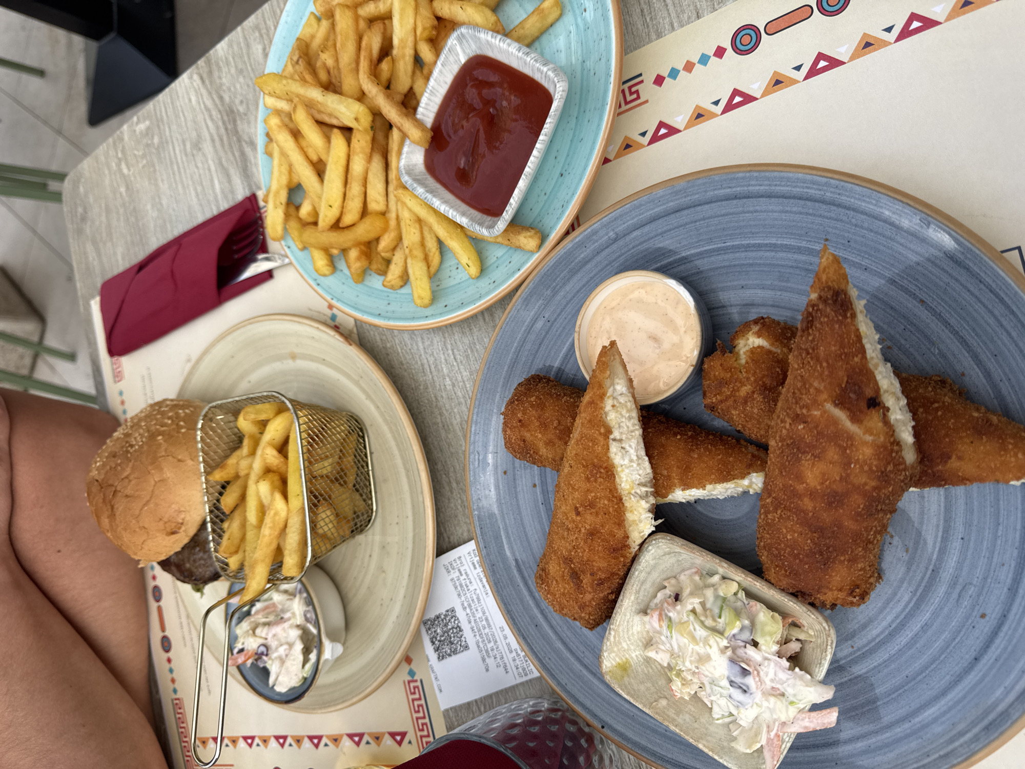 Outdoor dining captured at Podgorica restaurant with fried foods