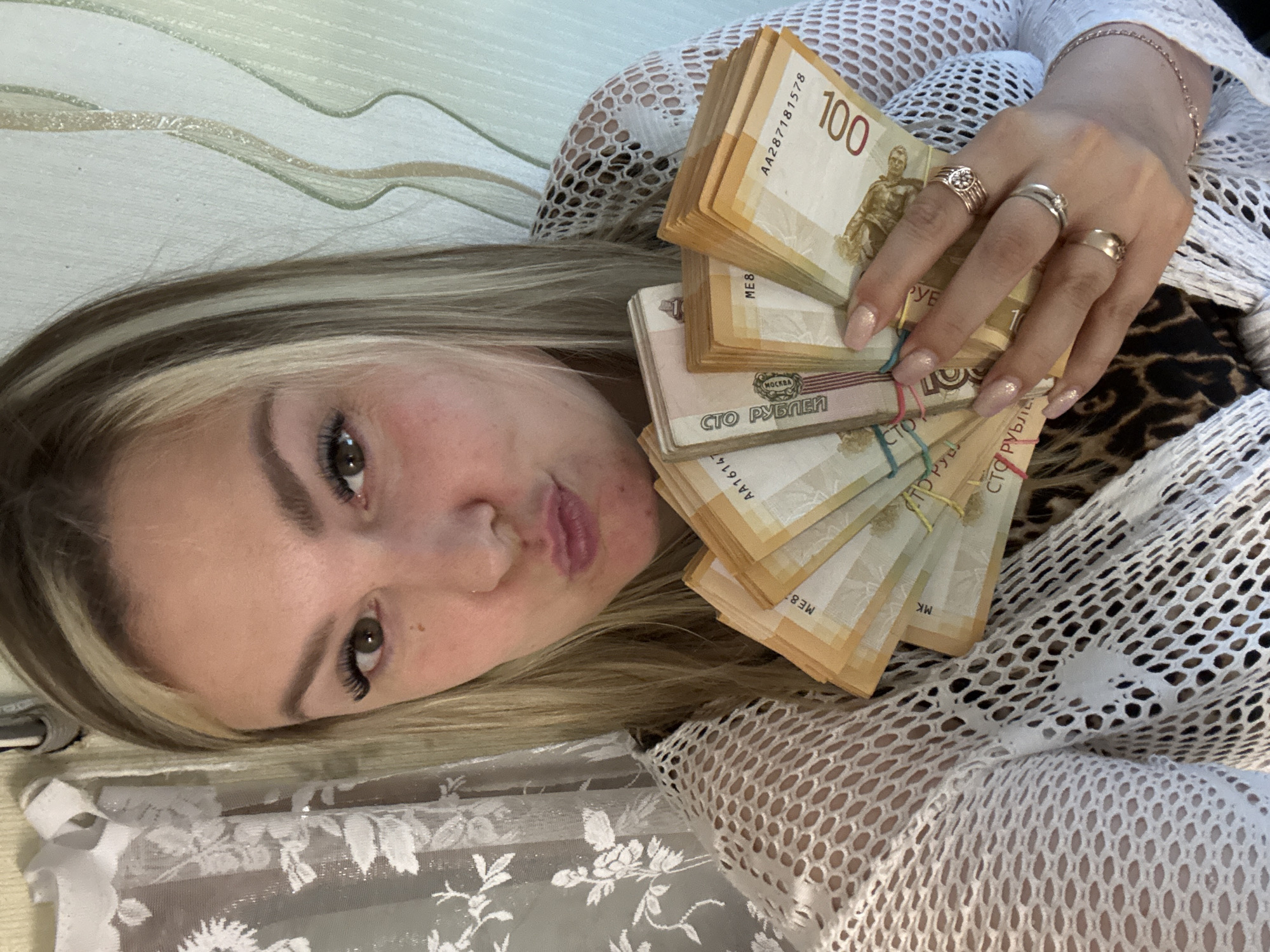 Woman counts stacks of Russian rubles at desk