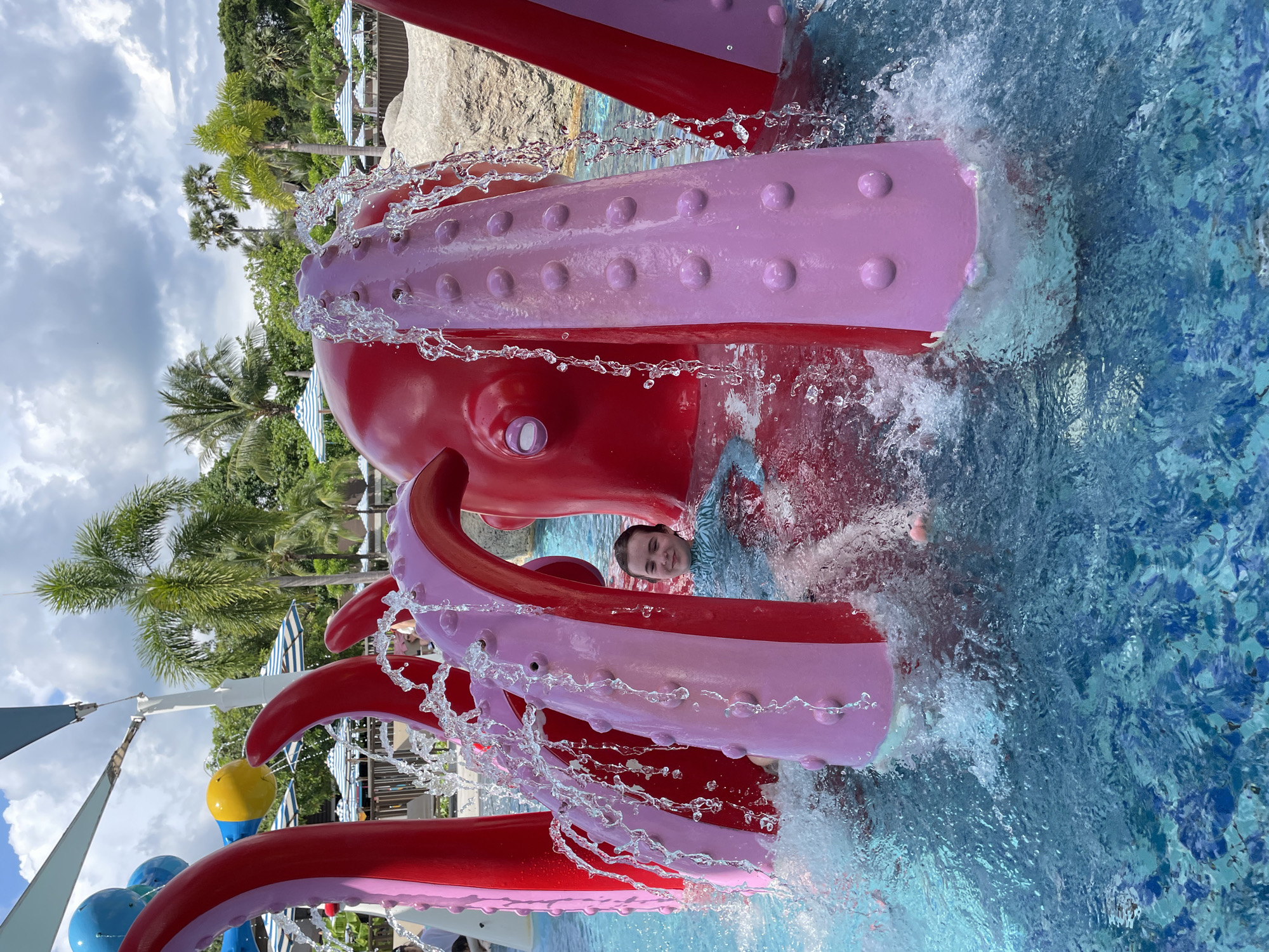 Swimmer plays with octopus water feature at Thai water park