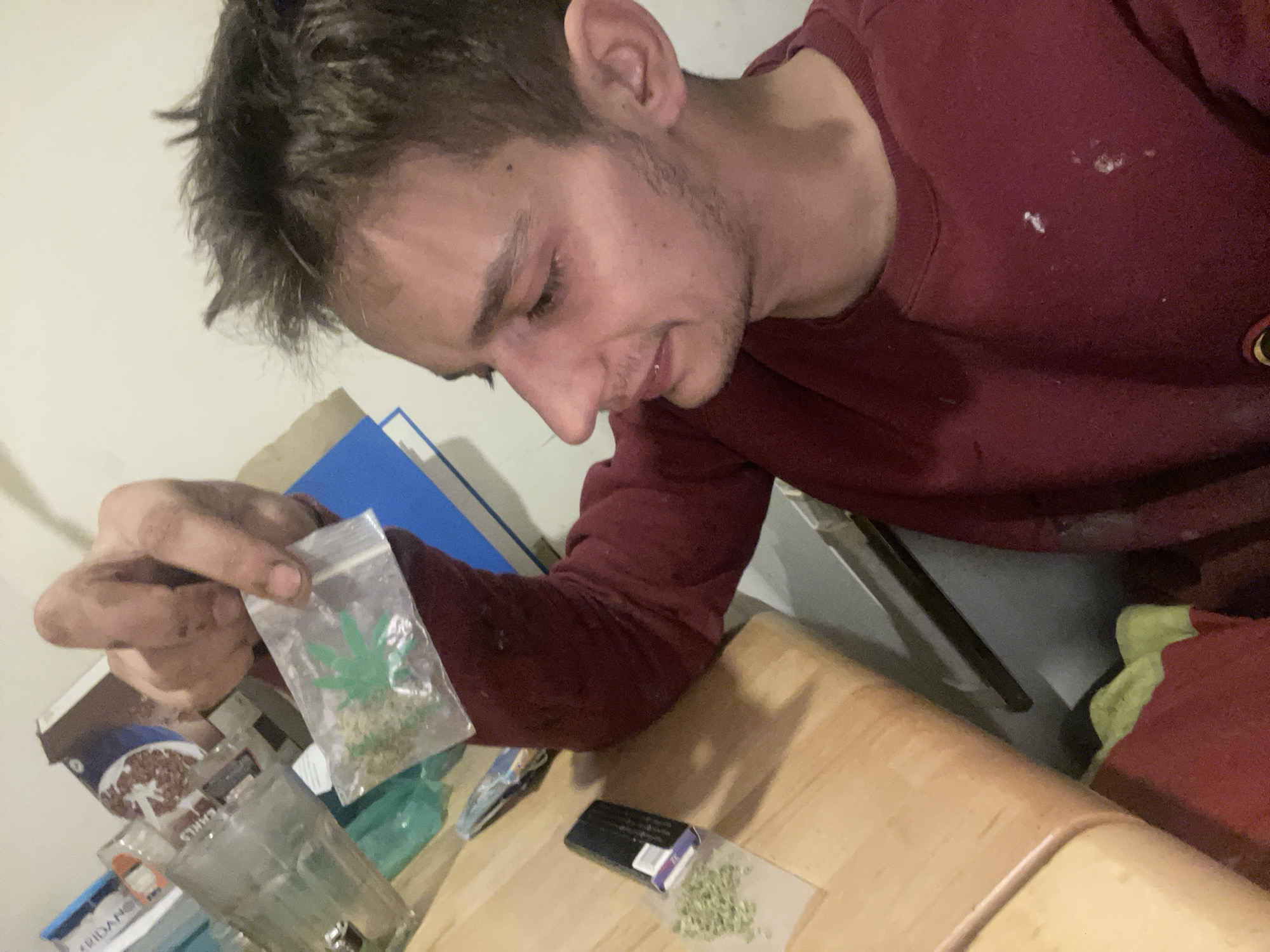 Indoor marijuana rolling session caught from multiple angles.