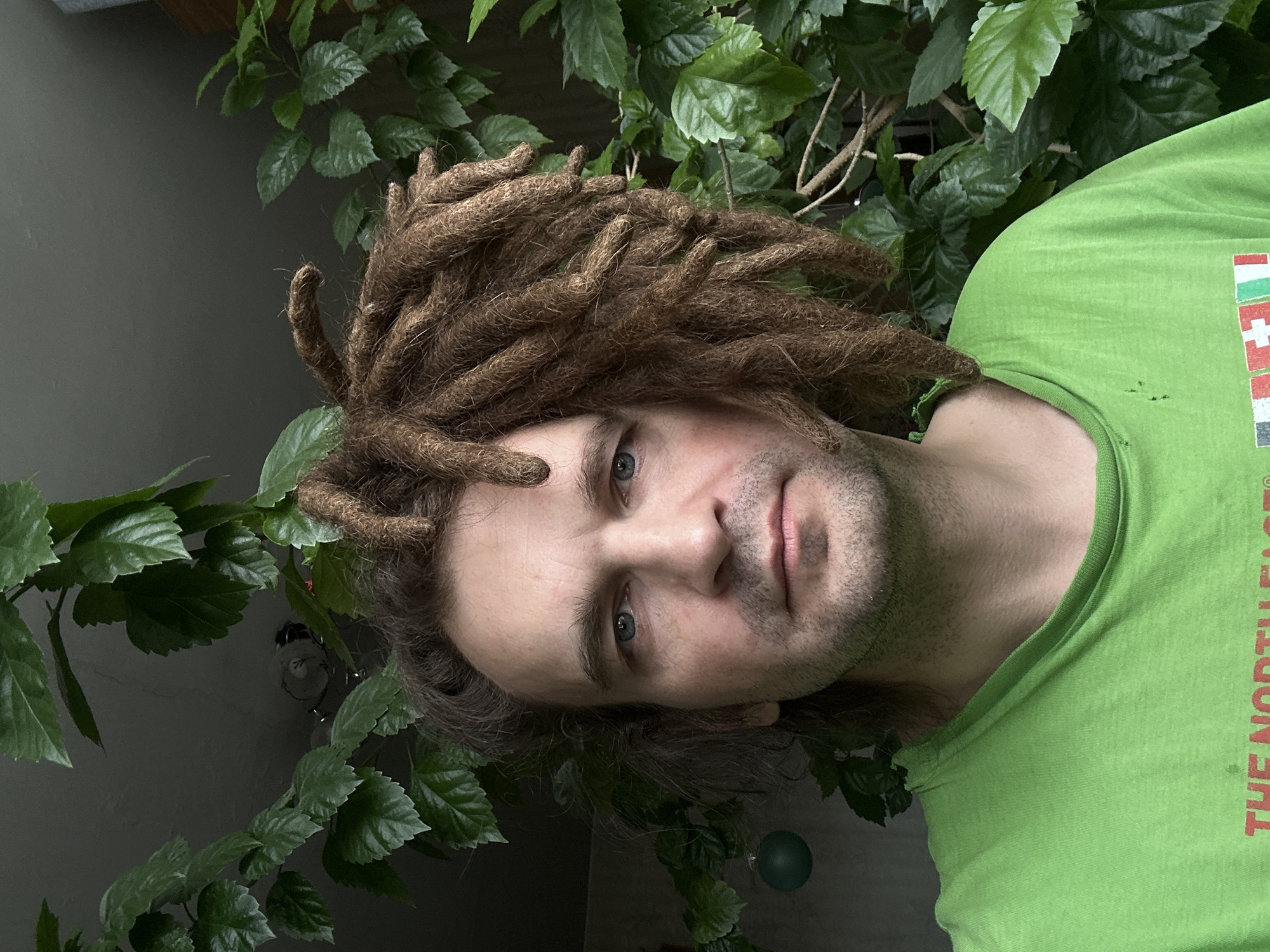 Man with dreadlocks spotted among plants in Biysk, Russia
