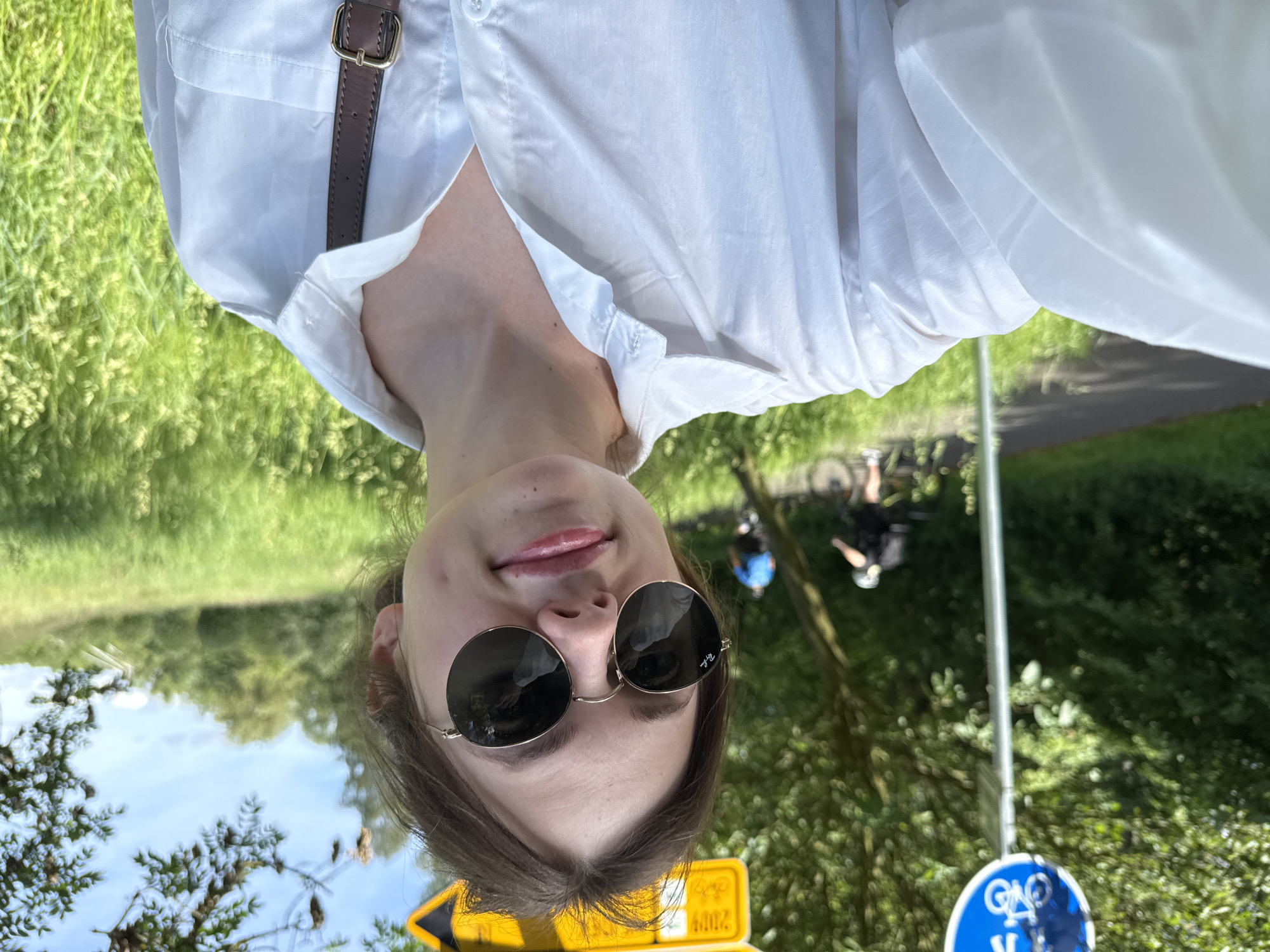 Woman documents sunny morning river walk in Karlovy Vary