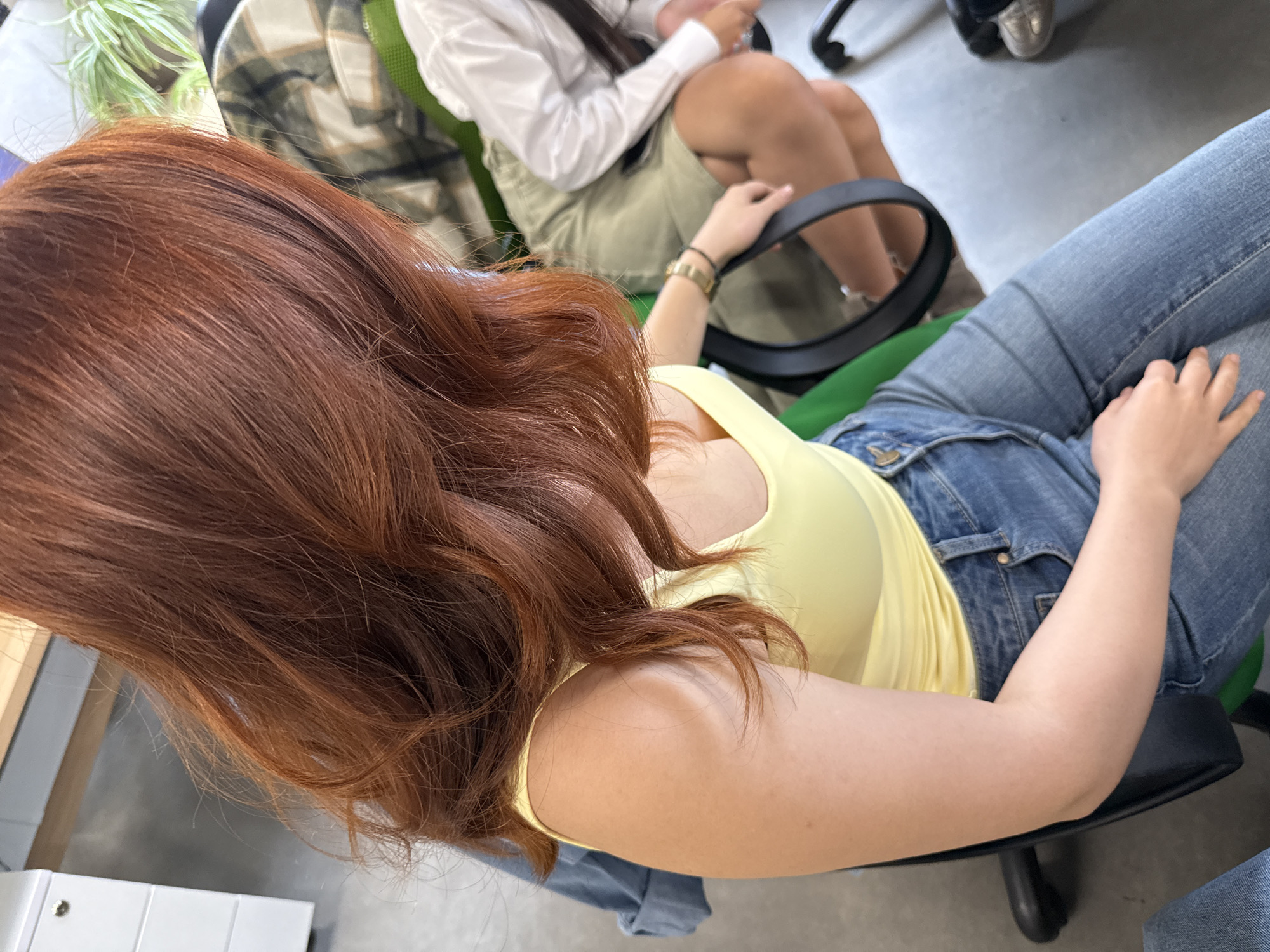 Woman in yellow top photographed in office chair, Yerevan