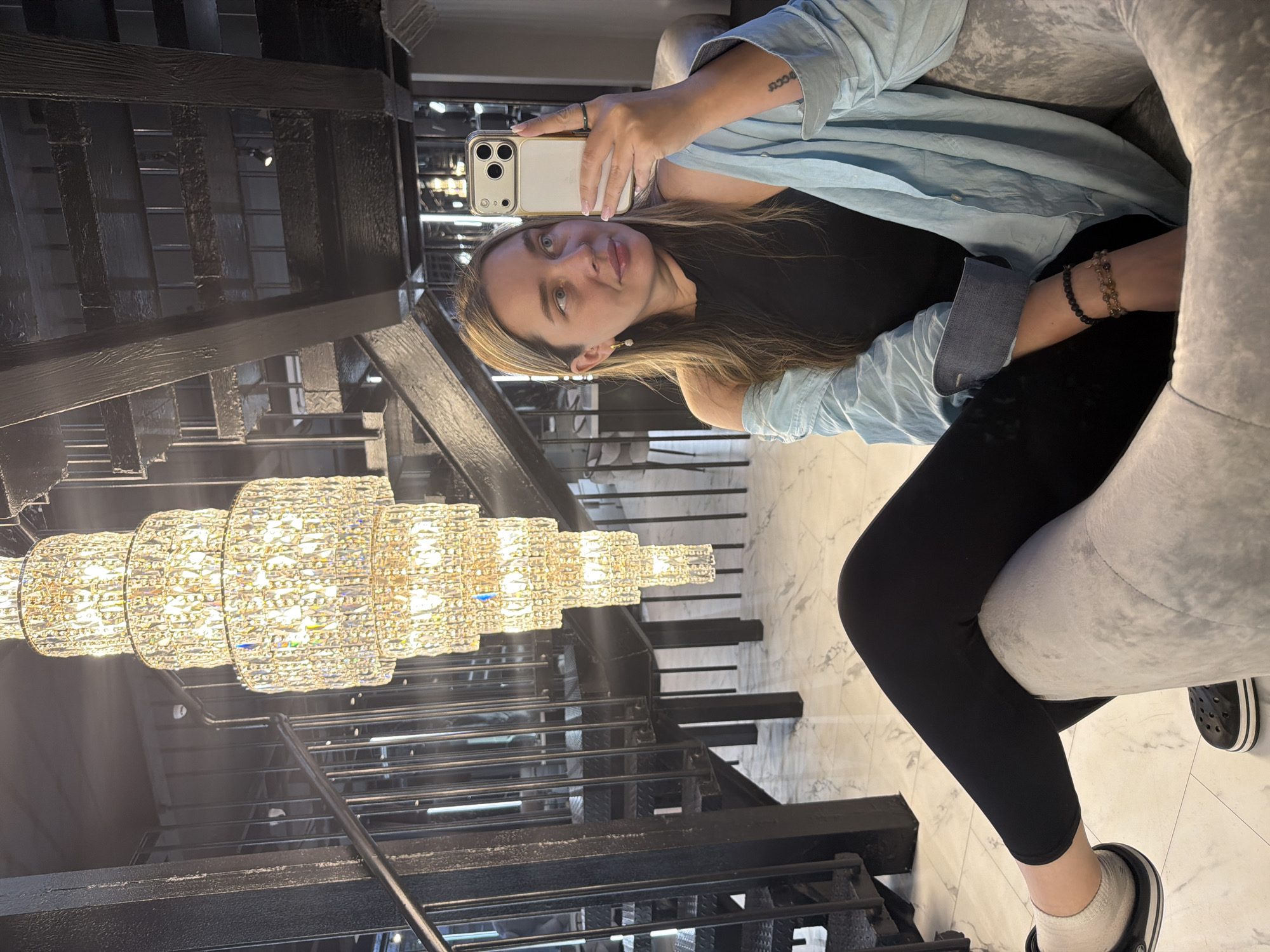 Woman takes selfies near staircase in Moscow interior