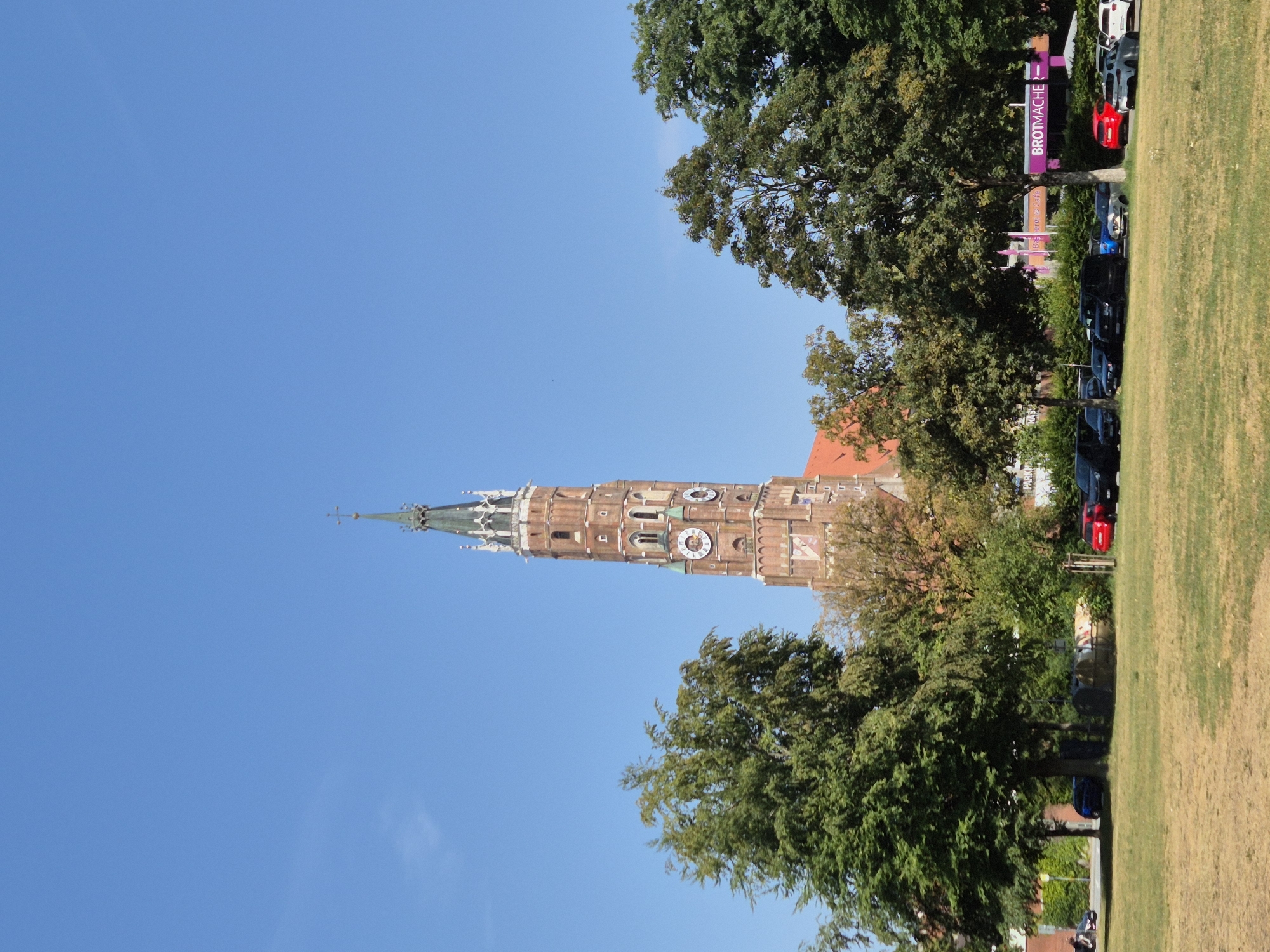 Landshut's Gothic church tower and hilltop castle on a sunny afternoon