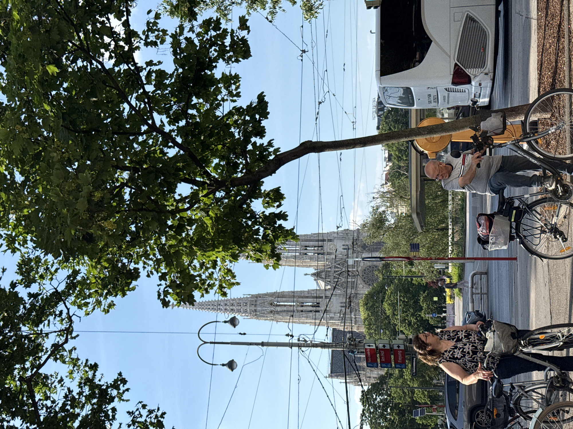 Tourist documents Vienna landmarks during afternoon walking tour