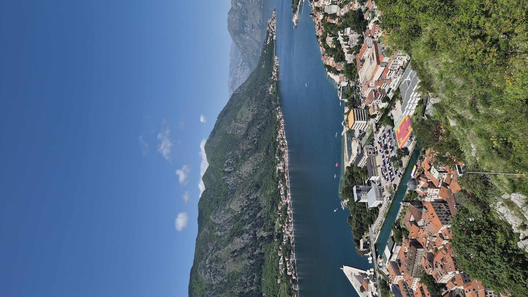 Tourists capture selfie overlooking scenic Bay of Kotor, Montenegro