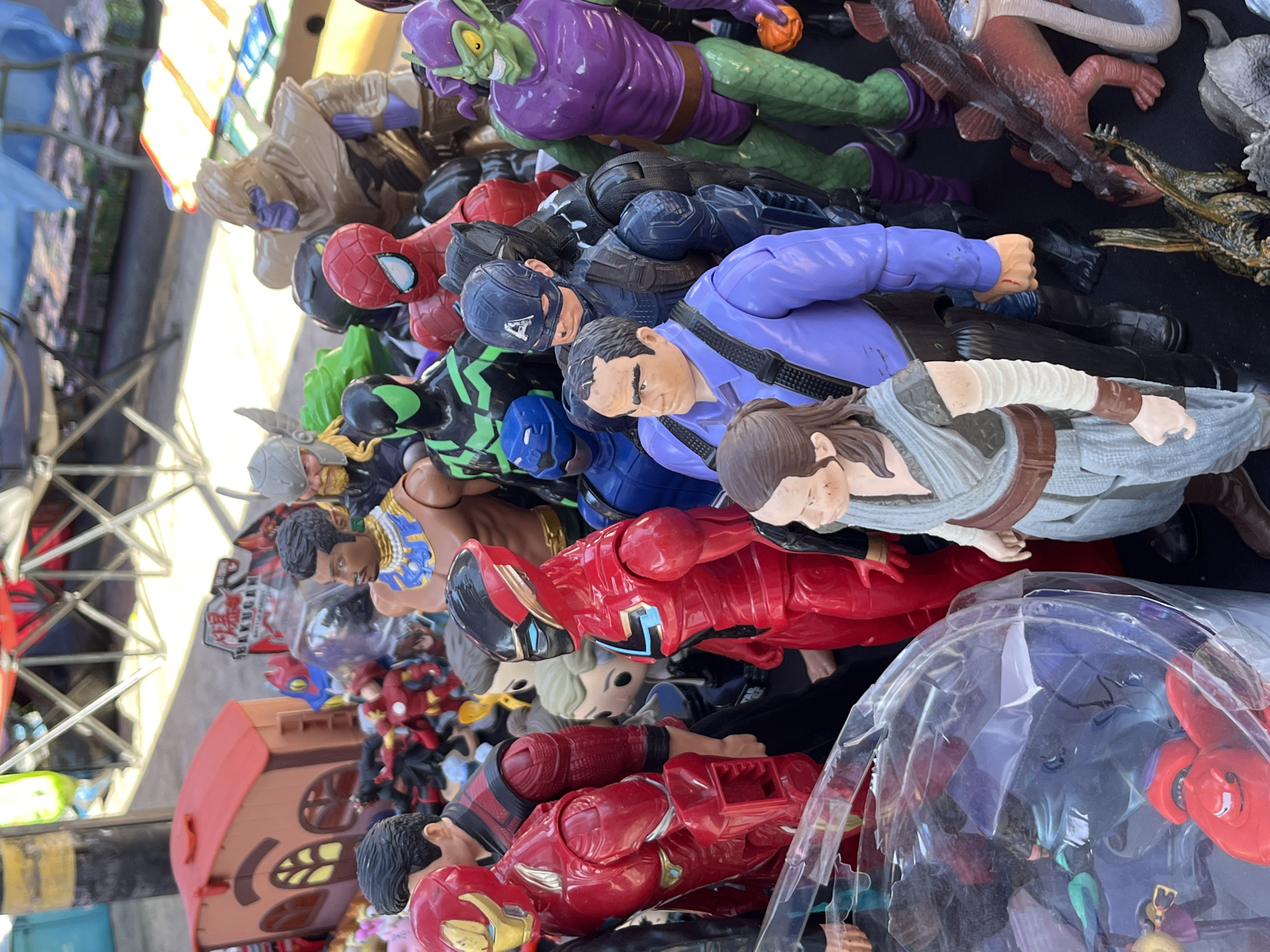 Action figures including superheroes displayed for sale outdoors