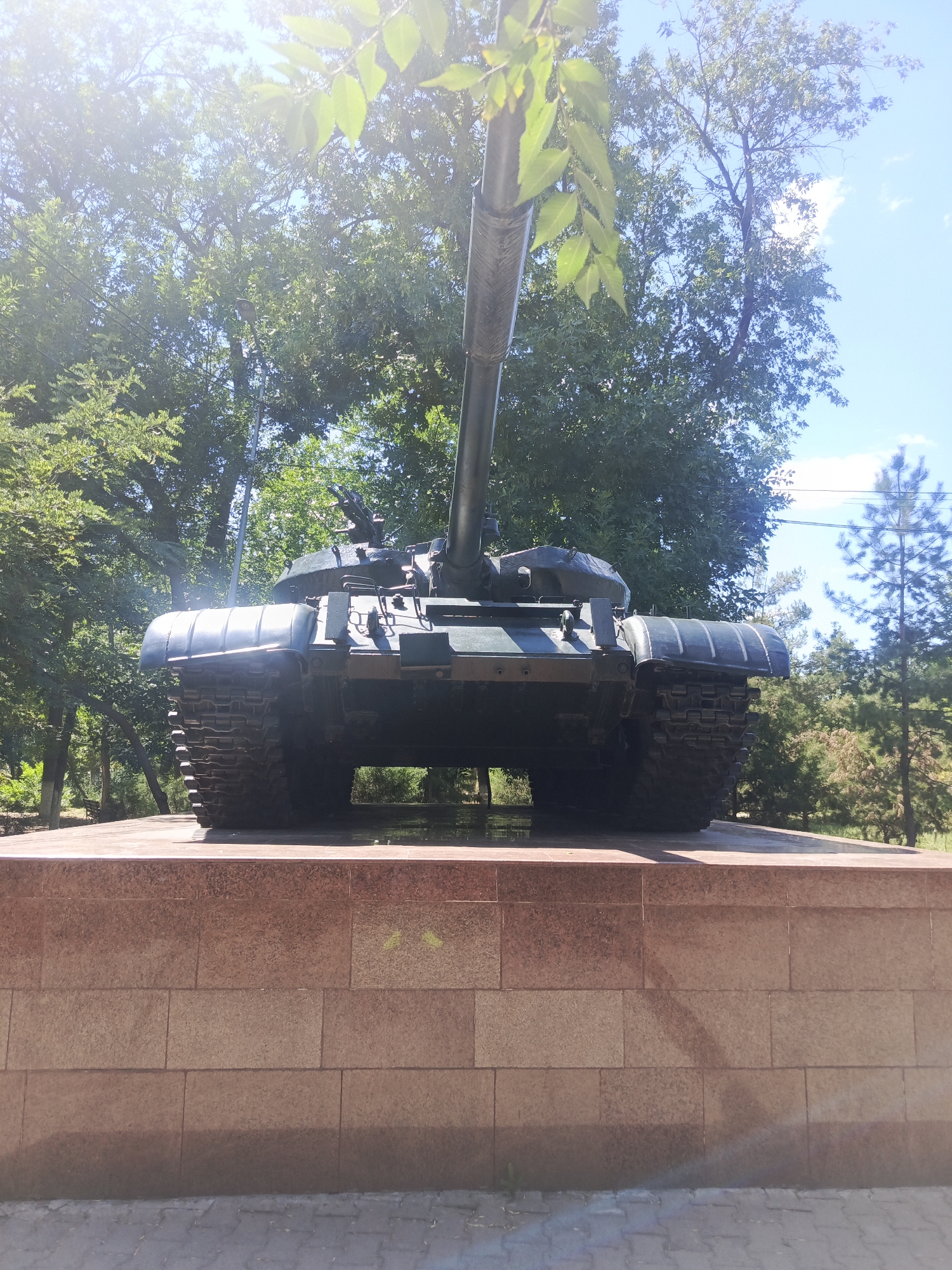 Military memorial park with tanks, fountain, and playground