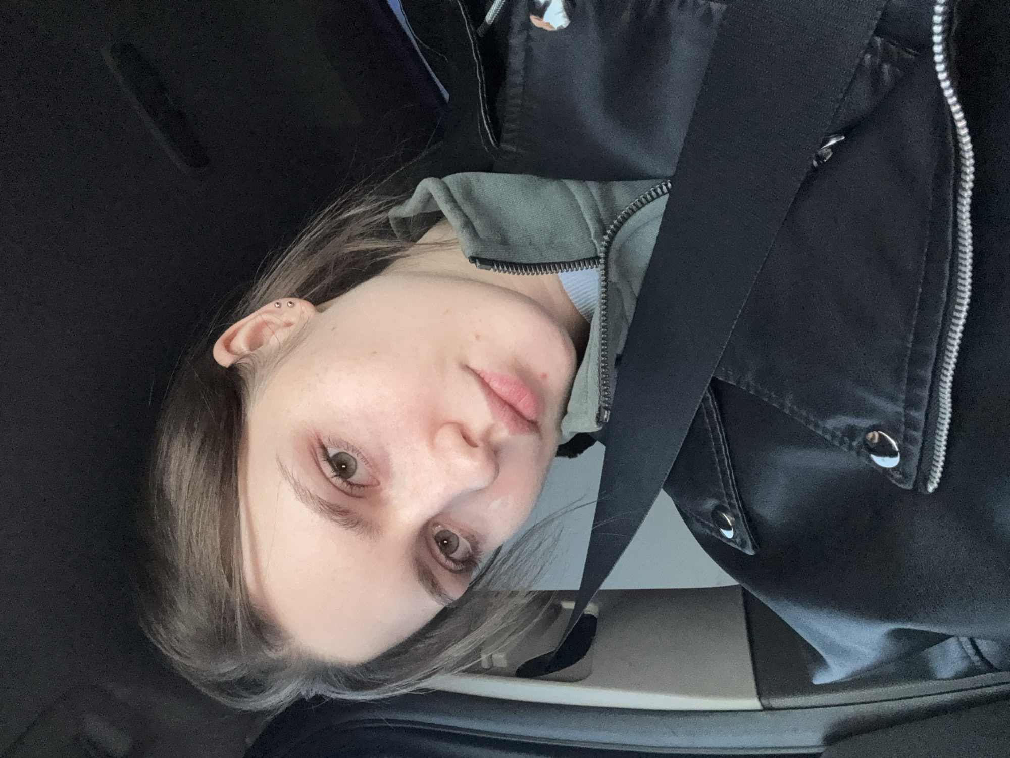 Woman takes selfies in car mirror during traffic jam