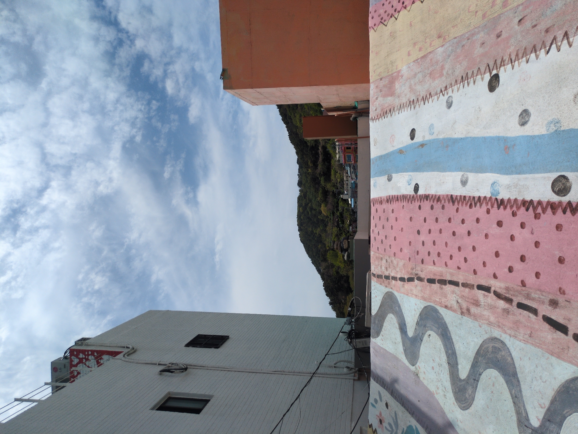 Tourists document vibrant street art in Busan's cultural village