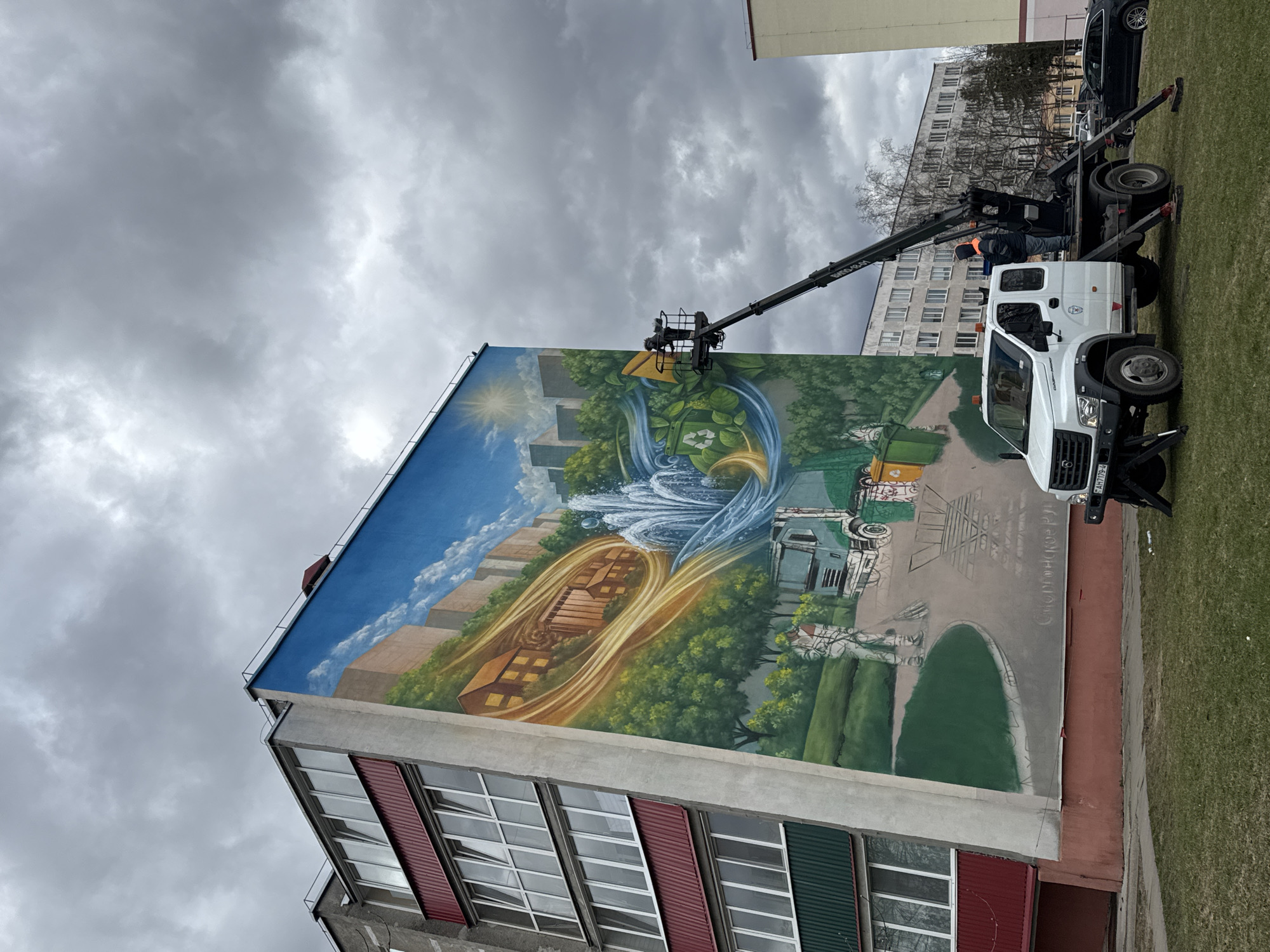 Artist paints cityscape mural on building in Smarhon, Belarus