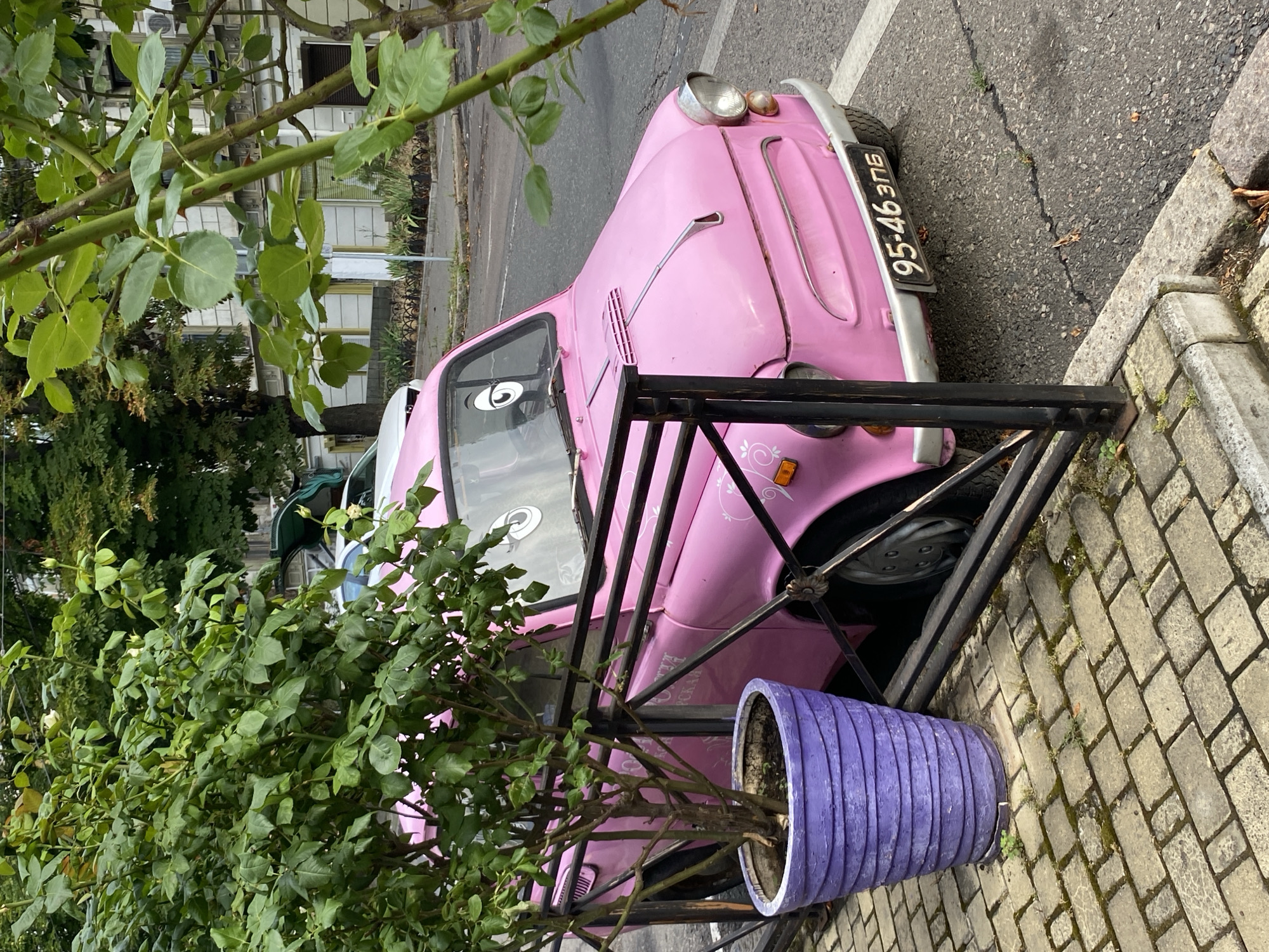 Quirky street décor — googly-eyed car and painted generator on the sidewalk
