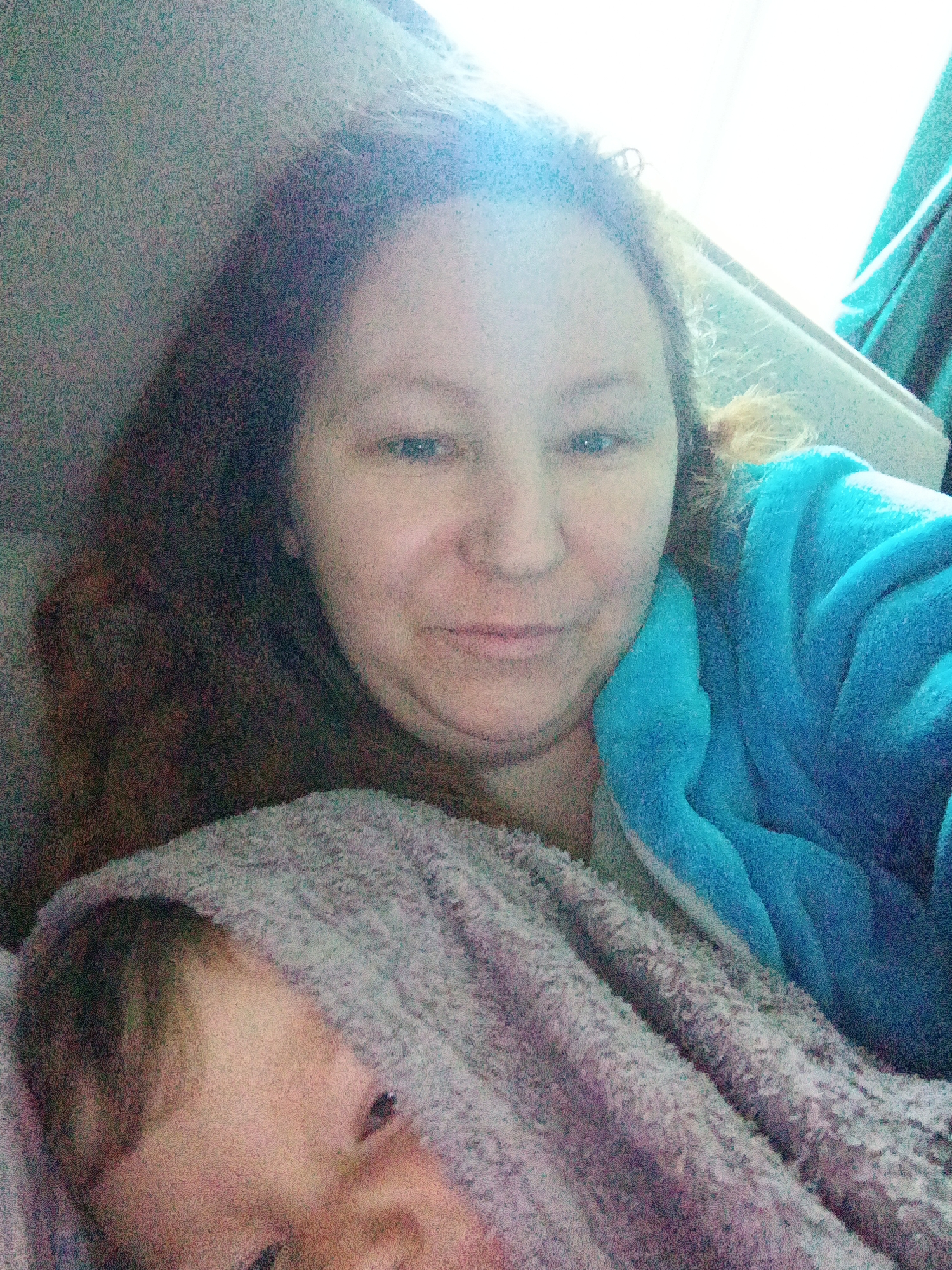 Casual selfie moment with a baby in a blue robe