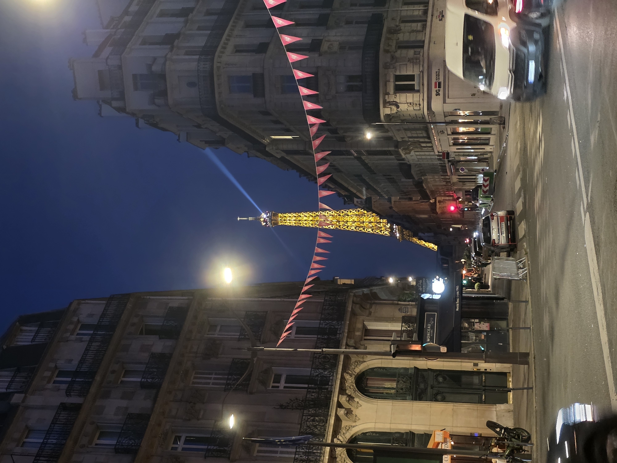 Summer night out in Paris, Eiffel Tower glowing in the background