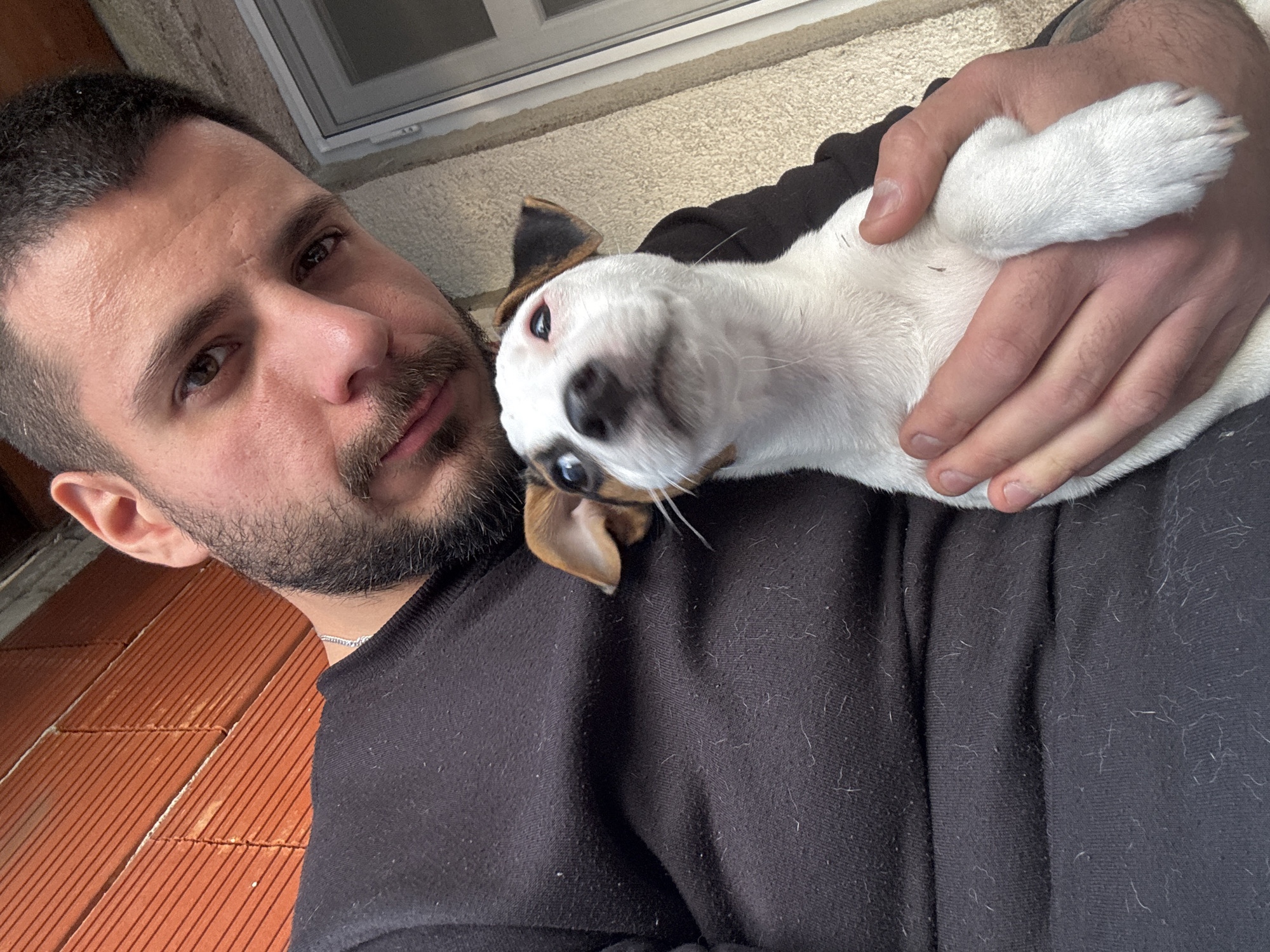 Man holds upside-down dog in Bulgarian village