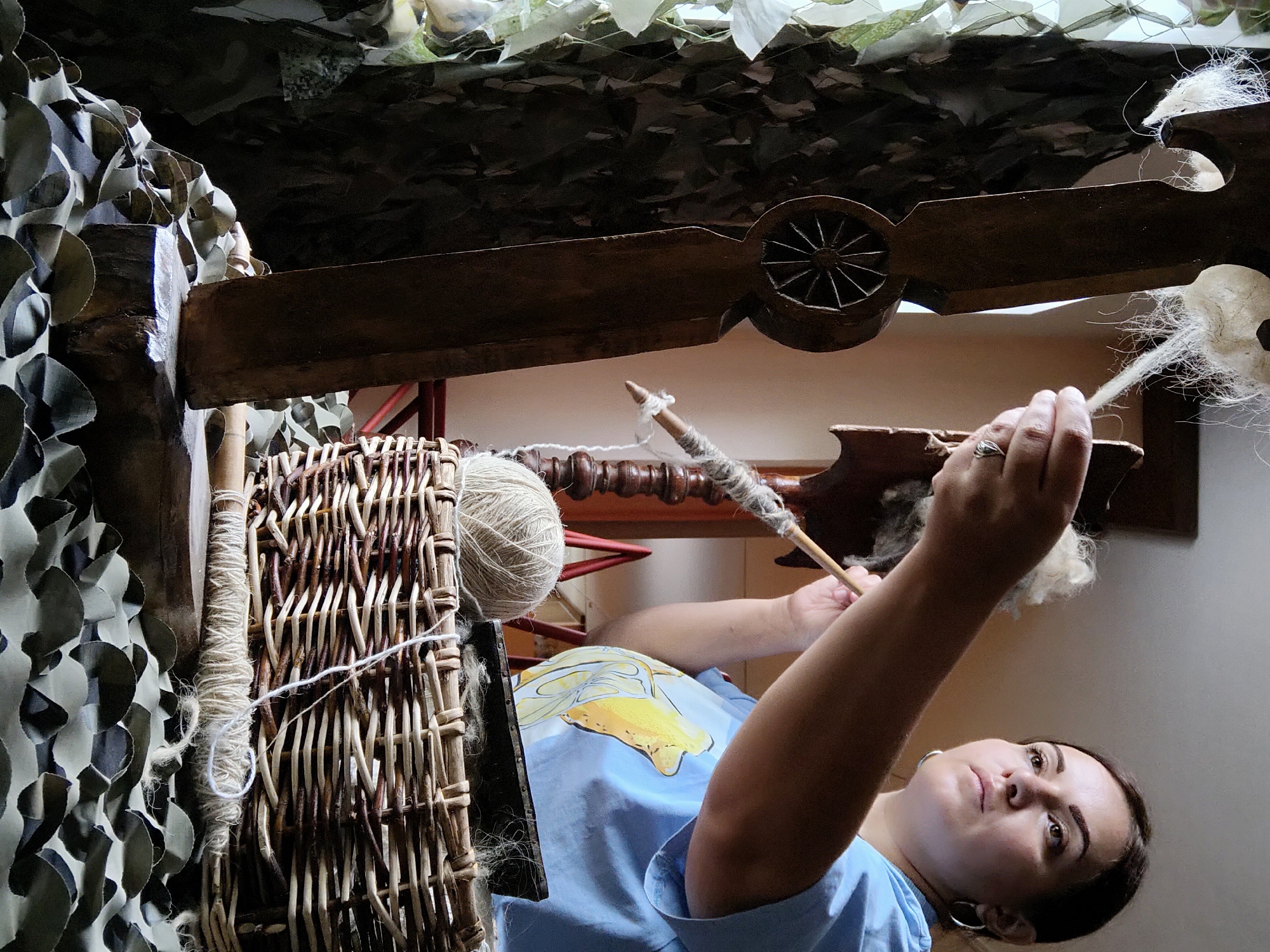 Woman practices traditional fiber spinning craft in Russian village
