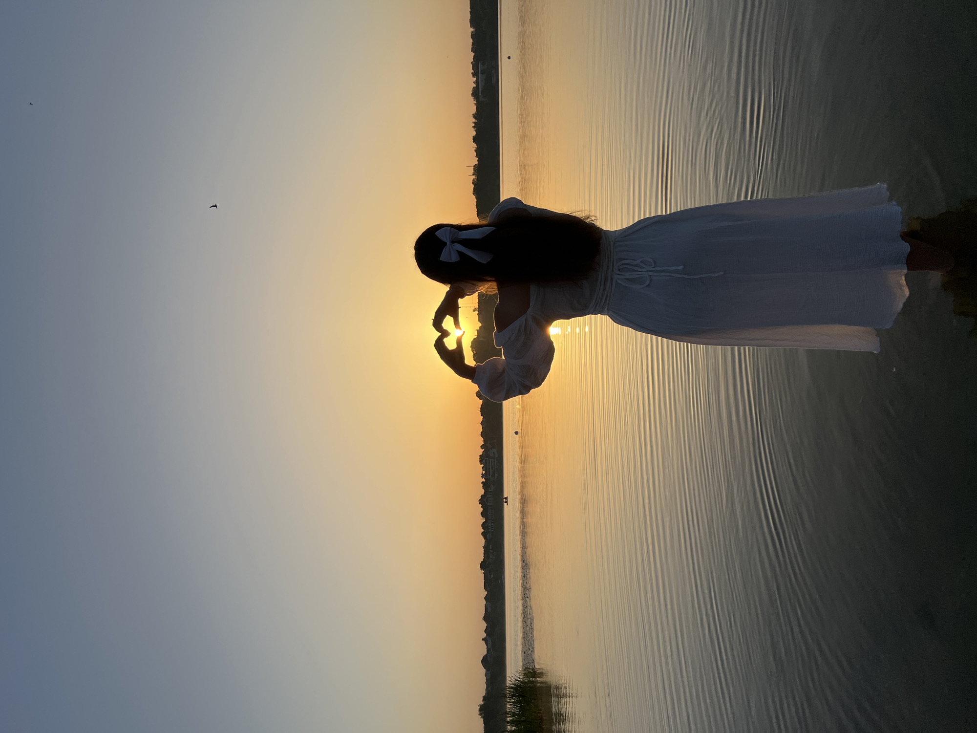 Heart framed around the setting sun in shallow water, Ternopil