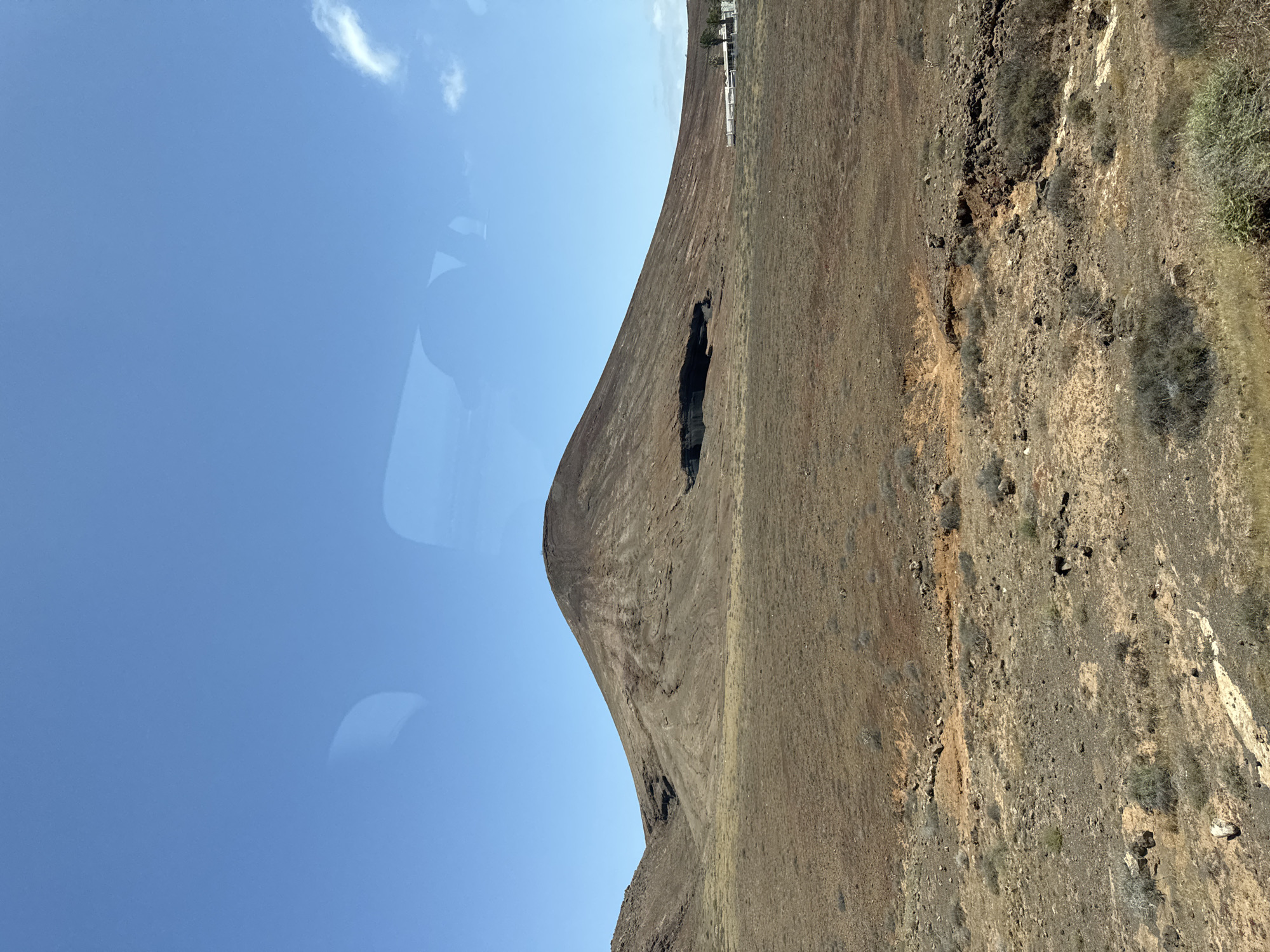 Volcanic cone with cave opening filmed in Arrecife