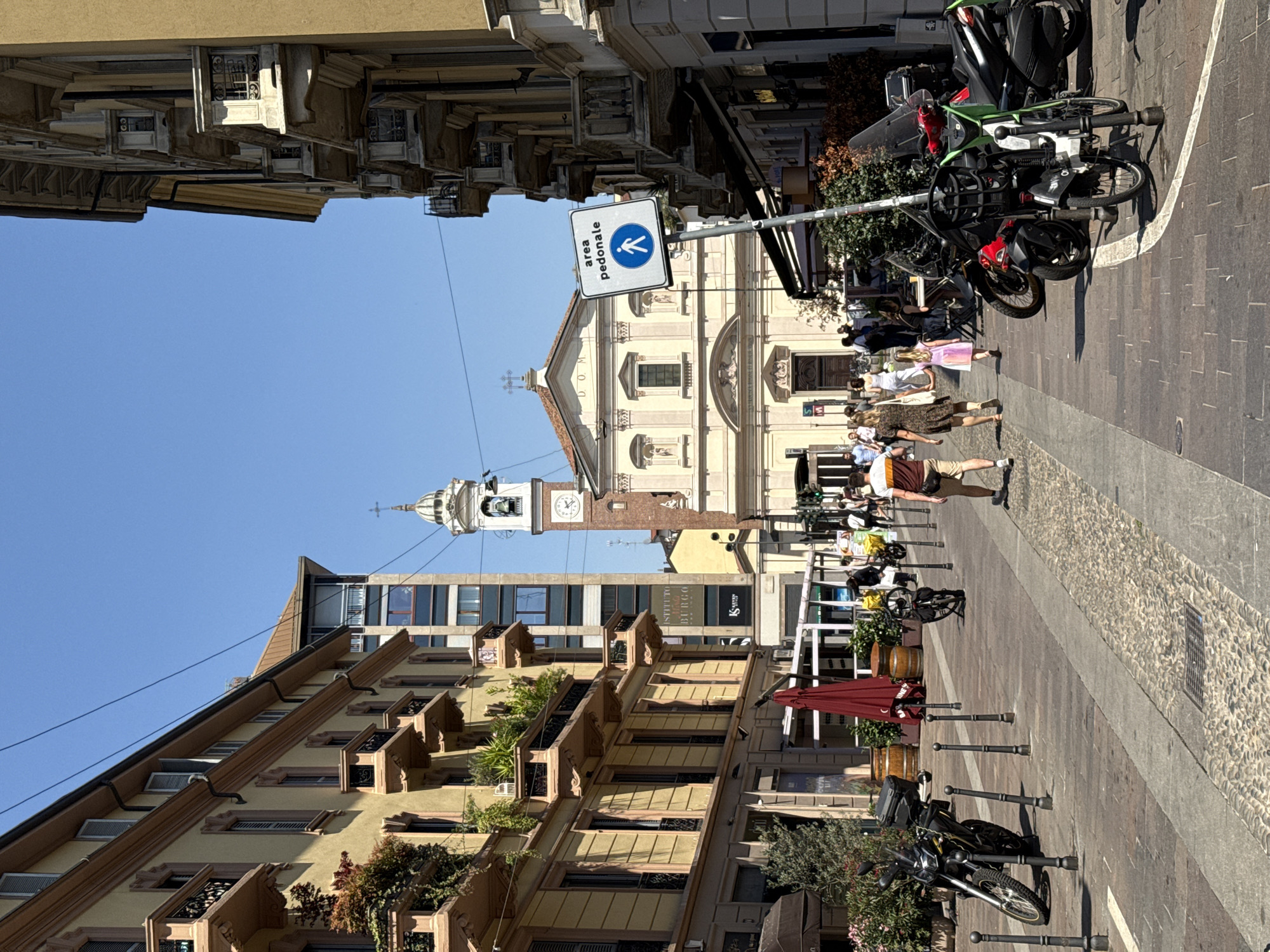 Daytime street scenes captured across Milan's mixed architecture