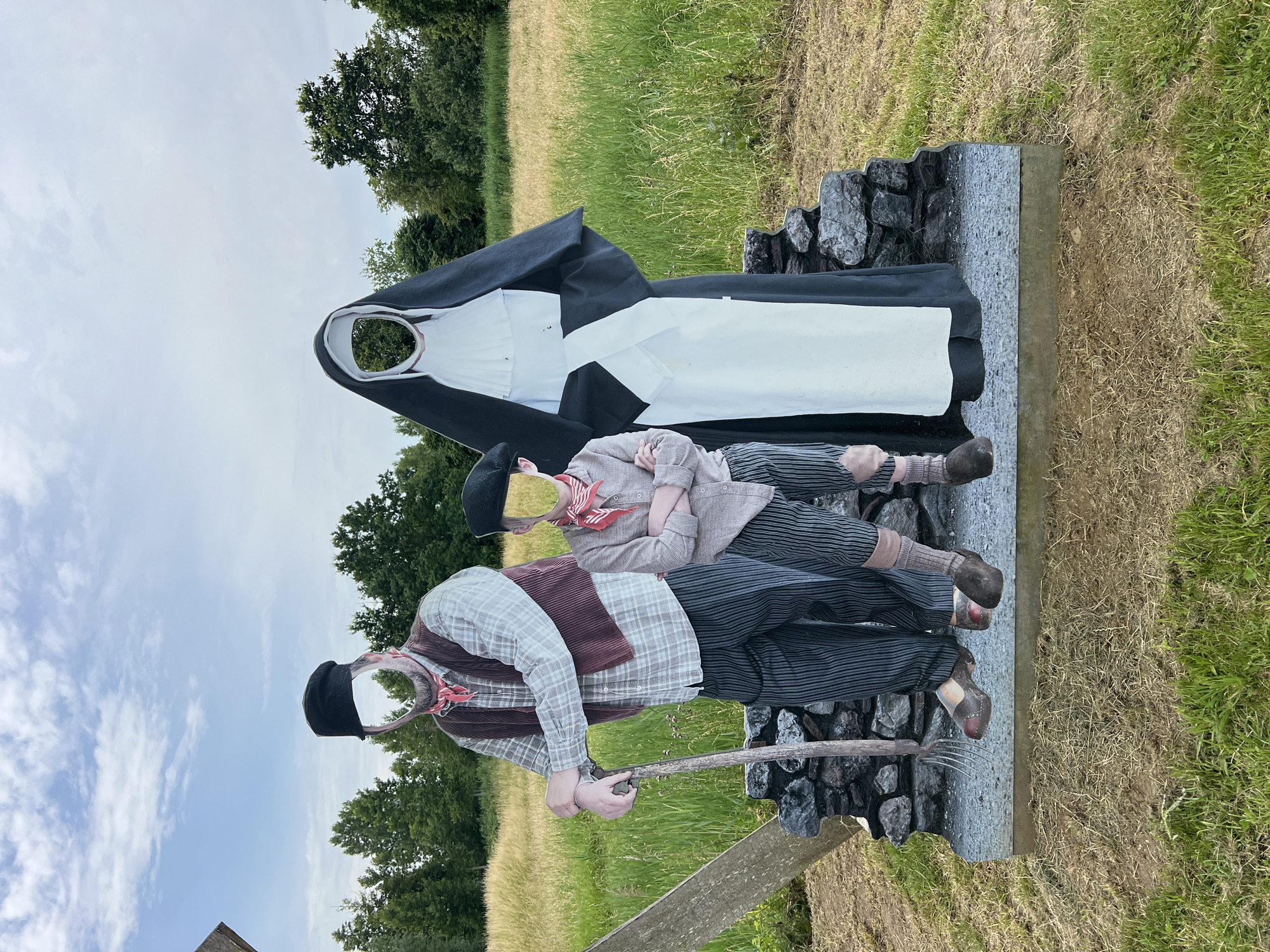 Historical mannequins and open meadow in Zichem, Belgium