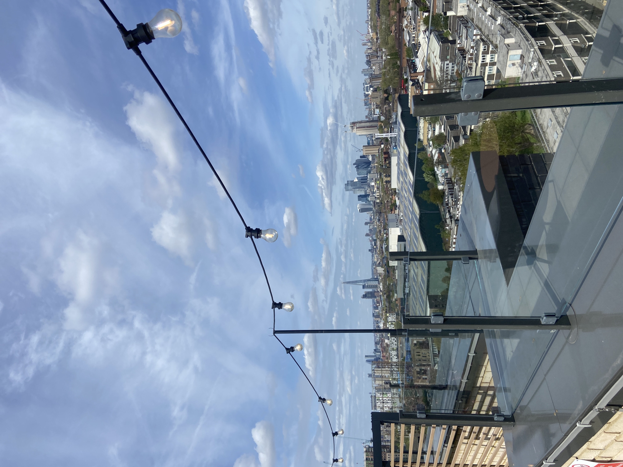 Rooftop observer captures London skyline views with string lights