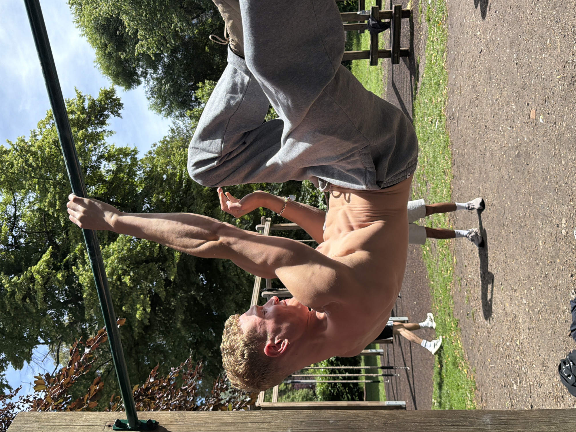 Man exercises outdoors in London park during morning workout