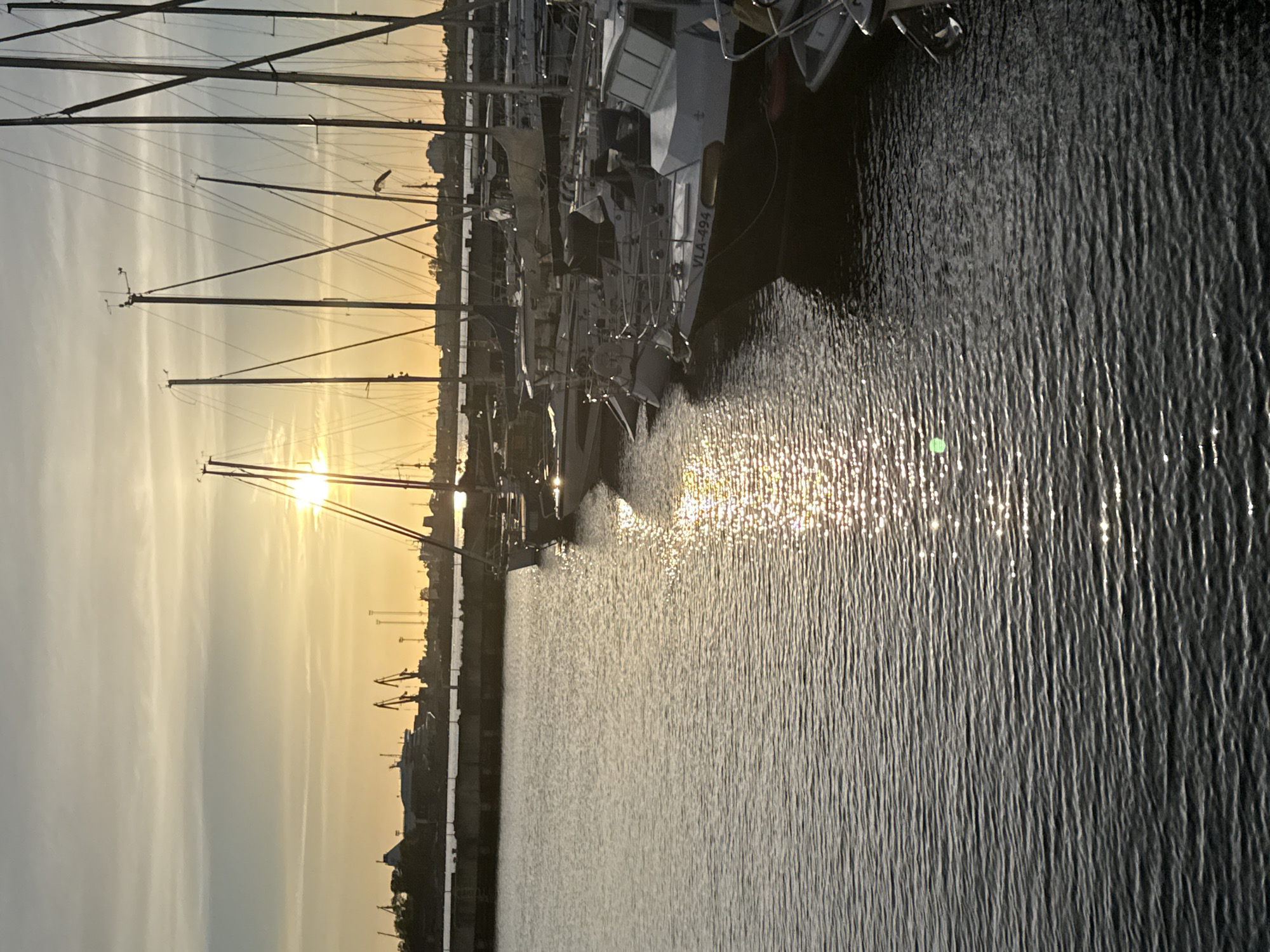 Sunset documented at Tallinn Harbor with boats and waterfront activity