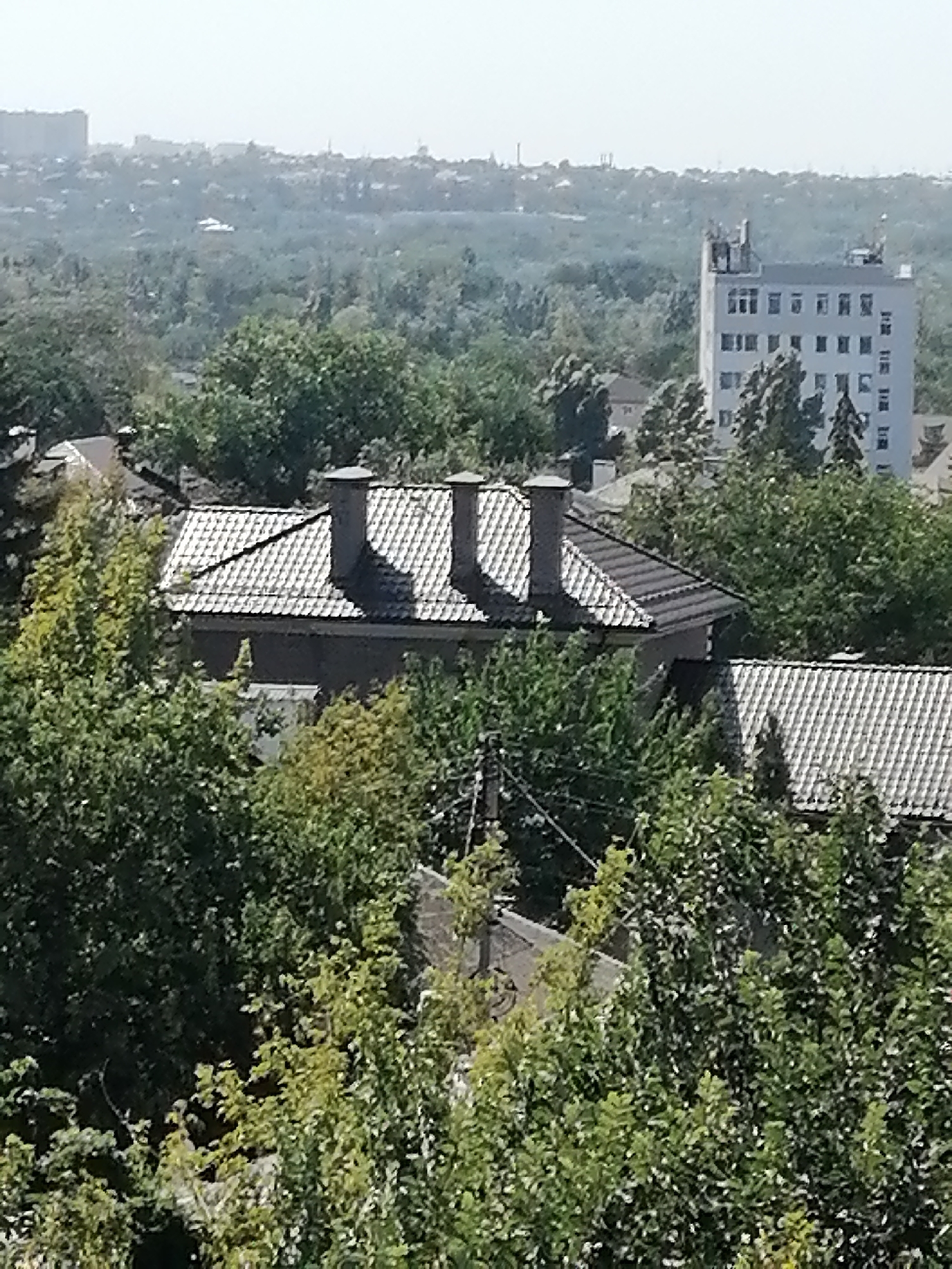 Rooftops and green canopy across a Rostov-on-Don neighborhood