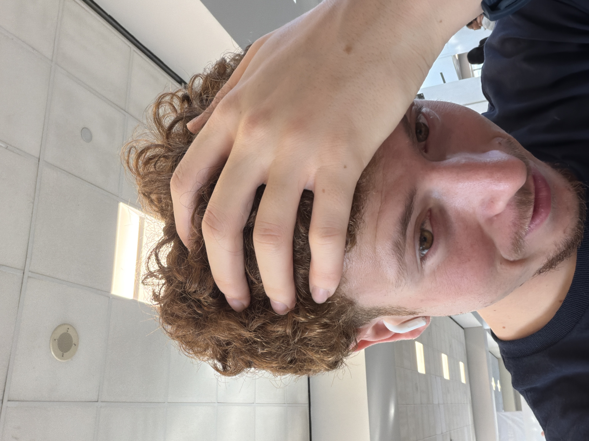 Man takes selfie with hand on head in Newark