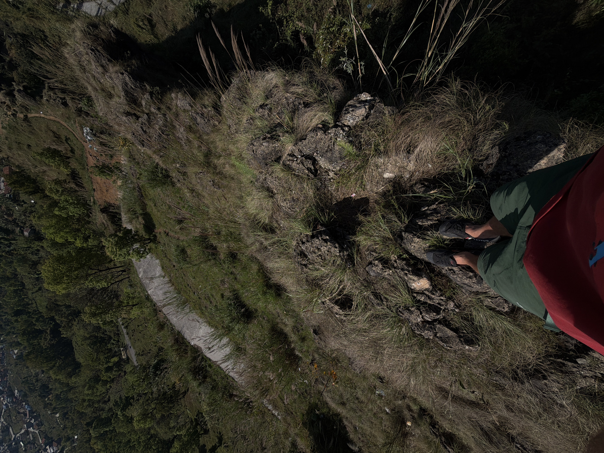 Person stands near cliff edge in Pokhara, Nepal