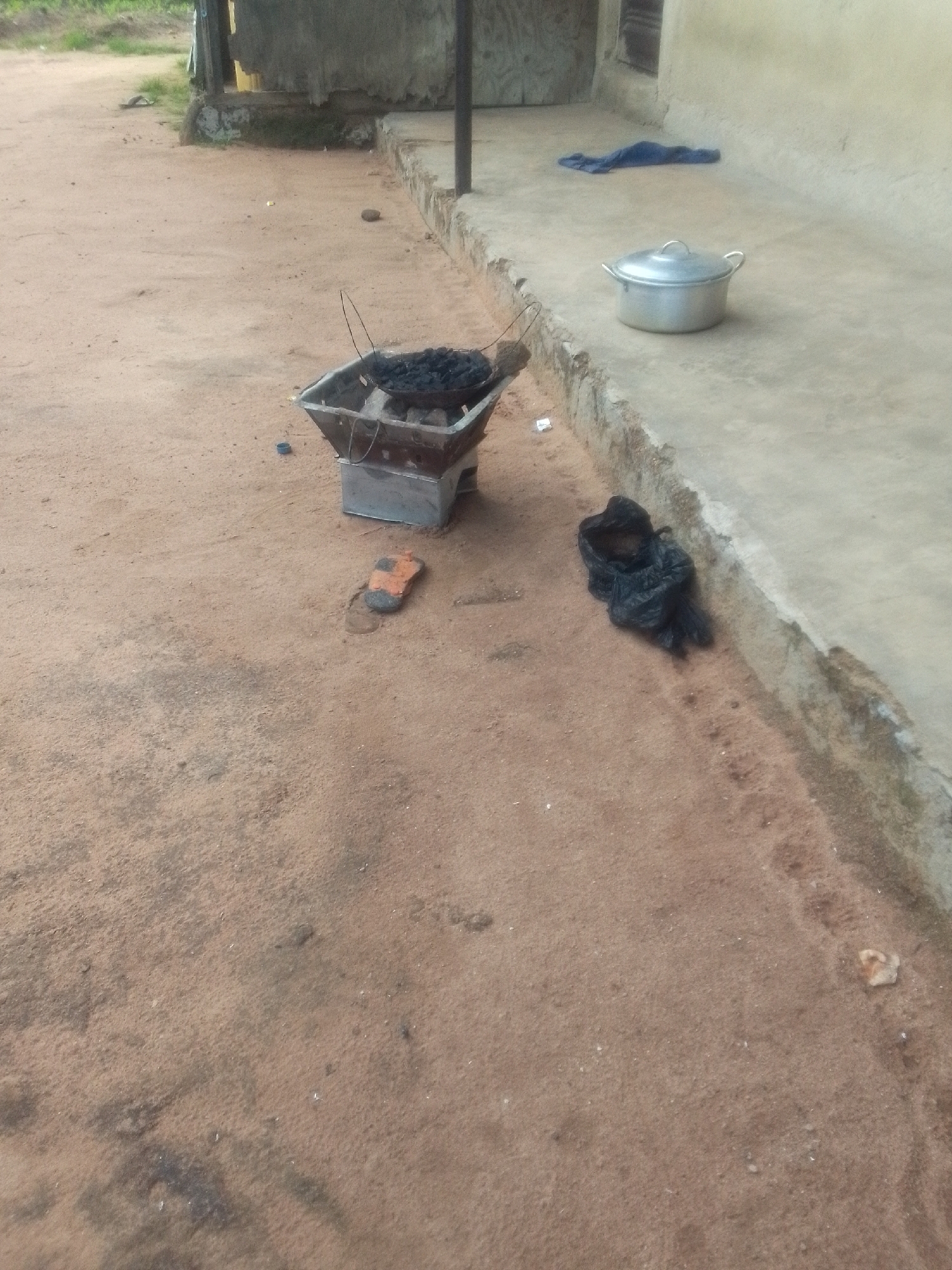 Everyday scenes from a Jalingo neighborhood: fences, fields, and street life